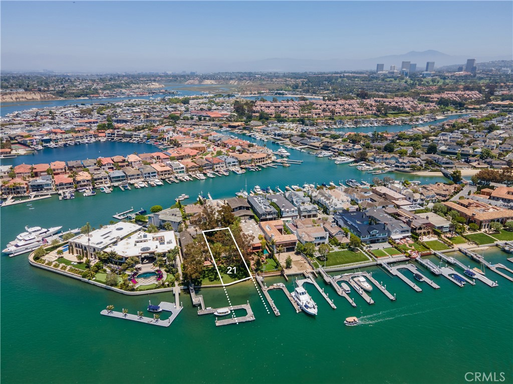 On offer is one of two lots from this iconic bayfront estate, being presented here in the form of one fifty-foot wide parcel with the address of 21 Harbor Island. Situated on Harbor Island - Newport Beach's most sought after address - and overlooking the main turning basin, this parcel features the very best views and the very best location one will ever find in Newport Beach on the water. This is a singular opportunity to acquire an unbuilt lot in an ultra-prime location upon which to create one's dream home on the bay. The building envelope is substantial and is complemented by a mature garden with stately trees and long green lawn running down to the water's edge. A relocated and reconfigured dock will accommodate up to an 85' yacht - possibly longer. No subdivision is necessary, as the lots have always been independent and were never merged. The home on the adjacent lot (20 Harbor Island) is available as part of a package offering of both lots for $59,000,000.