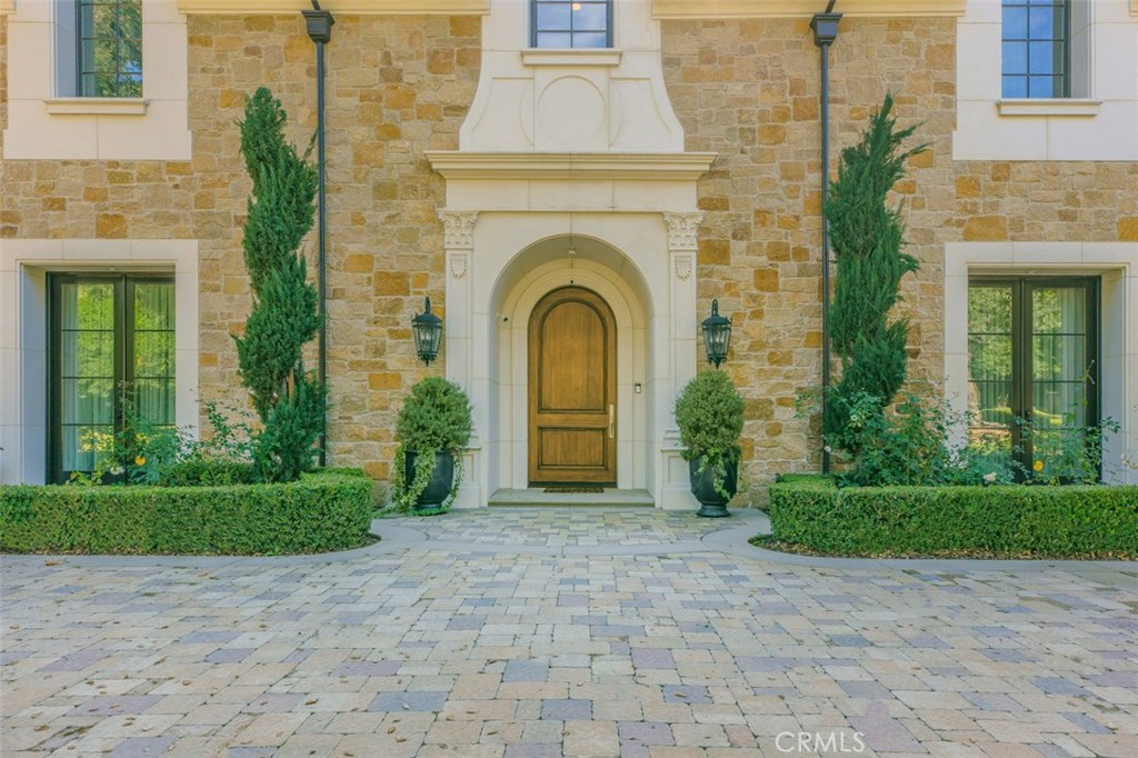 Welcome to 800 Singing Wood. This magnificent work of art was built by Mur-Sol and designed by Robert Tong. Over 10,000sf of opulence on a 28,000sf professionally manicured lot, all situated on arguably the most coveted street in the Upper Rancho neighborhood of Arcadia. As you enter through the circular cobblestone driveway into the towering foyer you will immediately sense the grandiose that was envisioned by it’s designer. Formal living room offers windows that rise to the hand painted ceiling, bathing the interior with an abundance of natural light. Chef’s kitchen features wolf appliances and a separate fully appointed prep kitchen. Other features include a state of the art movie theater, elevator, gym with sauna and full bath, the list goes on. Main level consists of three en-suite bedrooms, one of them a secondary master. Second level features the spacious master suite taking up the entire west wing while the east consists of two en-suite bedrooms and gym. Every attention to quality and detail has been implemented into this masterpiece.