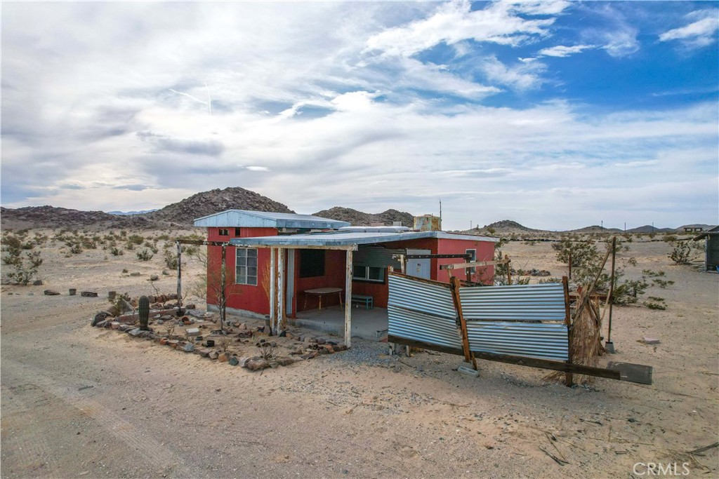 Escape to wide open skies and endless potential with this unique 5-acre property in Wonder Valley, California. Situated in the heart of the Mojave Desert, this parcel offers the perfect blend of privacy, space, and opportunity for the creative buyer. The land includes a single-family residence structure ready for a full renovation or reimagining—whether you're dreaming of a desert getaway, a minimalist retreat, or an off-grid artist's studio, this property offers a rare chance to bring your vision to life. The existing home holds a designated SFR status, giving you a head start with zoning and planning as you transform it into your own desert sanctuary. While the structure currently needs updating, it provides a solid foundation for those looking to design something truly custom in a striking and serene location. The property is not currently connected to power, but utility poles are nearby (buyer to verify all utilities and land use). Alternatively, the site is well-suited for solar infrastructure, appealing to those looking to build a sustainable, off-grid lifestyle. There is also an old water tank on the site. This is a great location for a desert adventurer who wants easy access to attractions like Joshua Tree National Park and Mojave Trails National Monument. With sweeping desert views, remarkable sunsets, and the quiet beauty of Wonder Valley all around, this property invites you to create something exceptional. Whether you're looking for solitude, inspiration, or a unique investment, this 5-acre canvas is ready for your imagination.