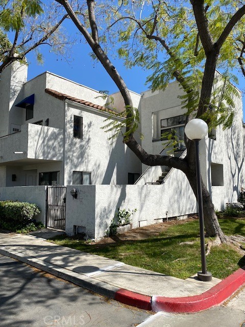 Lovely Condo!! Two Bedroom, two bath, two car garage (garage is directly below the unit). This end unit features lots of beautiful natural light, coming through many windows. There is laminate flooring throughout (except bathrooms have tile flooring), balcony view with some city lights, high ceilings in living room with fire place. Master bedroom suite features a with walk in closet, high ceilings, master bathroom. Indoor laundry room inside unit, central air and heat, kitchen has granite counter top, dishwasher. This property is in a private gated community with spa, BBQ area, pool within steps from unit. This property is in a very desirable area near parks, schools, restaurant and grocery stores.