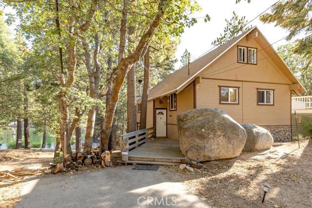 One of only 14 Lakeside homes in Green Valley Lake. Spacious floorplan with 1568 square feet, wood-burning fireplace, large kitchen plus pantry, living room, and den. There are 3 lovely and charming bedrooms and an additional sleeping loft and 2 full baths. Two of the bedrooms have beautiful lake views. Separate utility room with the washer and dryer. Super large back deck overlooking the beautiful lake of Green Valley. A hiking path steps from the property, fishing, paddleboats, and summertime full for everyone. Move-in ready and furnished per inventory. There's plenty of parking for all the family and friends. Turn-key and a real must-see!
