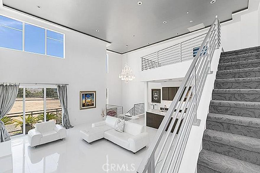 Beautiful modern 2207 square foot home with 3 bedrooms, 3 bathrooms in the chic urban enclave of Central Park West.  Prime private end unit southeast facing for ultimate sun exposure. Open floor plan with 23-foot ceilings in main living area.  Directly across from planned second park & pool. Nighttime views of skyline. Highly upgraded unit with Porcelanosa tile and backsplash, low voltage lighting throughout, towering crystal chandelier with lift, light box on ceiling and in master, and premium carpets. Custom California Closet in Master and second bedroom,  doubling as women’s dream closet. Trendy loft with great views of mountains and third private bedroom suite.  Perfect for guests, teenager, nanny or in-laws.   Custom cabinets and epoxy flooring in garage. This unit is simply the best of the Manhattans! This 2.2-acre community centerpiece features an approximately 8,000-square-foot Clubhouse and Recreation Pavilion providing both indoor and outdoor spaces designed to celebrate the Southern California lifestyle, including a State-of-the-art health and fitness center. Walk to Park Place shopping & entertainment including Houston’s, Mothers Market, North Italia, Lemonade, L.A Fitness and more. Minutes to John Wayne Airport, 405 freeway and the beach.