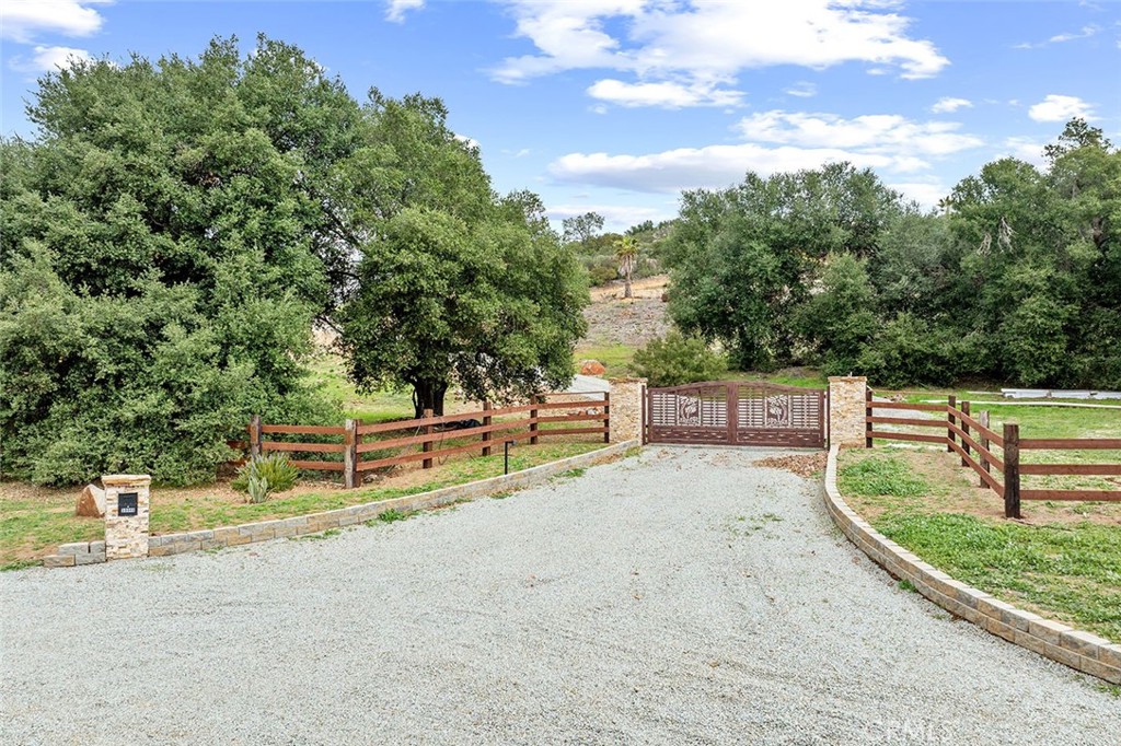 SELLER FINANCING AVAILABLE!!! 25-ACRE CROWN JEWEL OF LA CRESTA! SELLER MOTIVATED! BRING ALL OFFERS! This fully fenced parcel with power, water and Grading Permits for 2 pads & riding arena, is a once-in-a-lifetime opportunity to expand on the significant improvements that have been painstakingly made for several years, creating the Santa Rosa Plateau’s most notable estate site. The tour starts with the solar-powered custom stone & iron gated entry. Notice the moniker on the boulder at the street “Rocky Mountain Ranch”, giving a nod to the majesty of the mountain, sitting high above the entire La Cresta Valley. The views from all parts of the property are epic, especially from the top, where you will see the mountains of San Diego County, Mount San Jacinto, Mount Baldy, the entire Temecula Valley, magical sunsets and inspiring sunrises. In addition, follow one of the property’s gravel roads to the seasonal stream, vineyard and flat meadow below, a perfect spot for equestrian development and/or further agriculture. The 400-foot deep private water well and expansive irrigation system assures that you will have ample water from your own property for watering the existing vineyard, palms & fruit trees. It’s your water, so you will have the pleasure of knowing you can plant to your heart’s desire, without the expense of city water. The irrigation system continues throughout the property, including the vineyard, front fence line and dramatic entrance. A 2-inch water conduit is pulled all the way to the top, and an SCE electric meter has been installed (at great cost) to supply power to the well. A 3-inch electrical conduit has also been trenched and pulled to the top, saving thousands of future construction dollars. If you have waited for the pinnacle parcel to build your dream compound, do not miss this! It’s a WOW from the moment you see it! *****SANTA ROSA PLATEAU: 5-acre minimum parcels (10-acre minimum. in SR West), just minutes to schools, restaurants, hospitals, grocery stores, 15 Fwy & Temecula Wine Country. Enjoy this peaceful ranch community w/no commercial businesses, robust social activities, miles of private community trails & 1000s of acres of Ecological Reserve…All less than 1.5 hours from LA, SD, OC, Palm Springs & Big Bear. Discover the country, yet convenient, lifestyle of La Cresta, Tenaja & the Communities of the Santa Rosa Plateau!