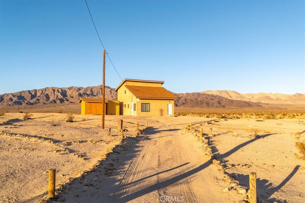 Here is a diamond in the ruff. A cabin next to nothing but Government Land. The original structure has been expanded and a second story added. Property is a 2 bedroom, 2 bathroom w- a loft, conventional septic tank and has more than 1200 square feet. The initial permits have been pulled, but they were not finalized. (Buyer to verity all square footage differential). Come complete this project and make it your own. Electricity is hooked up and comes w- a 2000 gallon water tank. Also included in the sale is the Shipping Container and the Trailer on the property at no additional cost. Of all the places in Wonder Valley to get, this is the one. Unique is an understatement. Come make your dreams a reality.