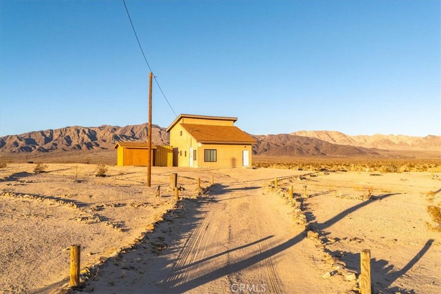 Here is a diamond in the ruff. A cabin next to nothing but Government Land. The original structure has been expanded and a second story added. Property is a 2 bedroom, 2 bathroom w- a loft, conventional septic tank and has more than 1200 square feet. The initial permits have been pulled, but they were not finalized. (Buyer to verity all square footage differential). Come complete this project and make it your own. Electricity is hooked up and comes w- a 2000 gallon water tank. Also included in the sale is the Shipping Container and the Trailer on the property at no additional cost. Of all the places in Wonder Valley to get, this is the one. Unique is an understatement. Come make your dreams a reality.