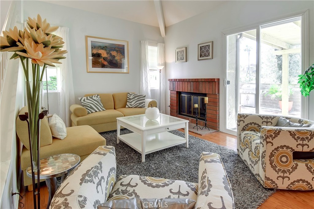 Welcome home to this beautiful end unit, 3 bedroom/ 3 bath turnkey condo in the quiet community of Crestline in Laguna Hills. Home is meticulously maintained and has been tastefully upgraded throughout. Kitchen is open and bright, w/white cabinetry, quartz counters, wood-like porcelain tile flooring, stainless steel sink, newer appliances, & recessed lighting.Enjoy the view out the large picture window over the sink. Custom wood/glass sliding doors separate the kitchen & dining room, enhancing the space while providing privacy. Living room & dining room are warm and inviting w/hardwood floors, brick fireplace, & vaulted ceiling. Access the patio from the living room or kitchen to enjoy the sunset under the custom patio cover. Your guests will enjoy the downstairs bedroom w/large closet. Downstairs bathroom has been remodeled with custom cabinet, fixtures, inlaid mirrors & lighting. Relax in the master bedroom suite, complete with spa inspired master bath, including dual sinks, granite counters, custom cabinetry, mirrors & lighting, custom designed tile flooring, & shower enclosure w/solid glass doors. Plenty of closet & cabinet space w/built-in drawers, including floor to ceiling mirrors w/shelving & storage behind. Secondary bedroom has a full en-suite bathroom. Laundry is conveniently located inside. All new double pane windows and sliding glass door. Attached 2 car garage with newer garage door. Bonus-back patio has it's own access gate!