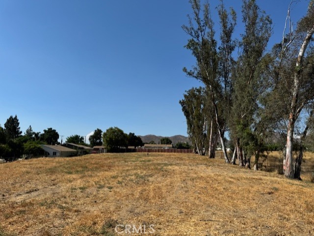 Just over 1 acre of flat land ready for a home or two.... Flat and usable, lots of improvements. 400 Amp on property, Gas on property, 1" water pipe. All set up for two homes on property. Septic area. Access is off a rock road close to freeway 15 and Elsinore High School. Beautiful mountain views with some towering trees. Must see... Seller Financing or Trading available....