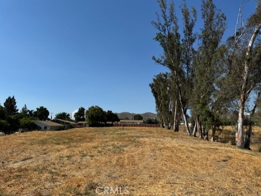 Just over 1 acre of flat land ready for a home or two....  Flat and usable, lots of improvements.  400 Amp on property, Gas on property, 1" water pipe.  All set up for two homes on property.  Septic area.  Access is off a rock road close to freeway 15 and Elsinore High School.  Beautiful mountain views with some towering trees.  Must see... Seller Financing or Trading available....
