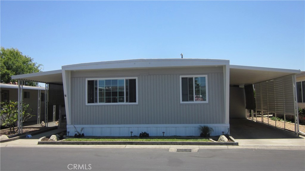 Mobile home in Lake Park Yorba Linda - 55+ Senior park. Approx 1100 Square Feet of living space. Home has 2 Bedrooms and 2 Baths. The Master Suite has his and hers wardrobe closets and dressing area. The guest bath is located across from the guest bedroom. The Living Room and Kitchen have nice views of the hills to the north. There is also a dining area. There is a new patio and patio cover and the patio has indoor/outdoor carpeting. The home has new dual pane windows, new hot water tank, painted inside and out, new skirting, new baseboards and recently serviced A/C and Forced Air Heat. Carport should fit 2 cars and there is guest parking across the street. The home backs up to a block wall so there are no neighbors directly behind you.