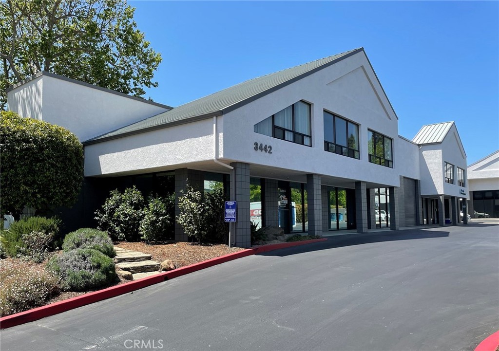 Space includes a reception area, private office, restroom on ground floor, and a large open work area (with built-in desks and cabinets) on second floor.