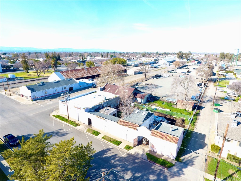 Great Commercial Building on Corner Lot - Stretching an entire block at the corner of Colusa and Sycamore street in Willows / This massive 4938 sq ft building is comprised of two warehouse style units with three service addresses and 3 phase power with a third unit in between , plenty of storage buildings as well as semi truck loading and unloading access along two streets (sycamore & coleus st) and the rear alley for additional loading access . This 1926 built building features a Spanish style frontage interio has office area as well as added storefront unit which could be rented separately .