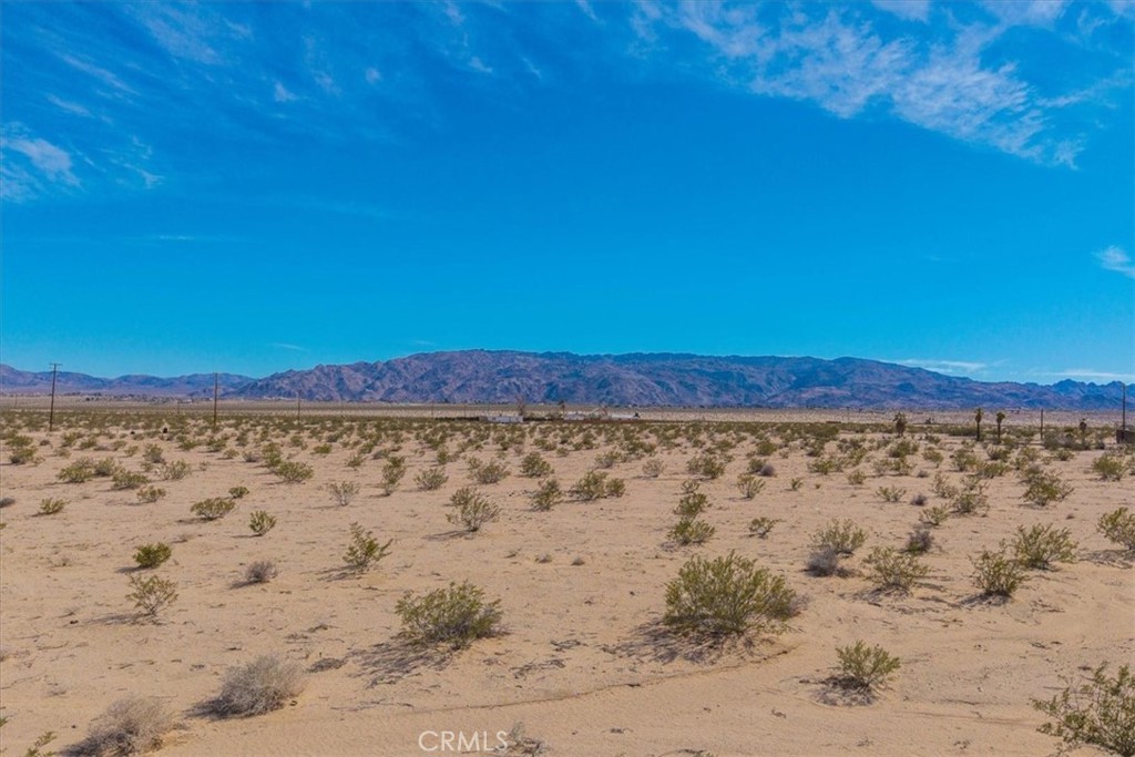 HUGE lot on almost 20 acres! CORNER LOT in the peaceful Desert Heights area of 29 Palms! Situated on the corner of Morongo Road (aka Desert Heights Dr) and Indian Trail, if you are looking for a large plot of land with great seclusion that is not far from the amenities of civilization, you've just hit the jackpot. Zoned for rural R5 living and already possessing a WELL, seller states the parcel also has the ability to access to county water via Indian Trail, and that there is already not one but TWO POWER LINES running to the property that can supply power to two separate meters. In the past, the land hosted two mobile homes for many years, but there is currently only a concrete pad left from the oversized 2 car garage that was once on the property. Consider the land a blank canvas upon which to paint the dream home of your visions. With all the options for water and power available here and a lack of protected desert plants, building should be as carefree as the desert breeze (buyer to verify all utilities and land use). Walk the land and take in the stunning 360 degree views that encompass nearly the entire Morongo Basin. You'll be thrilled to know all this peace and quiet can be had without sacrificing any convenience, as the property is less than 10 minutes to downtown 29 Palms and just a few miles to the back gate of the USMC base. Come check this one out for yourself to see why it's the perfect parcel for your next Hi-Desert building project!