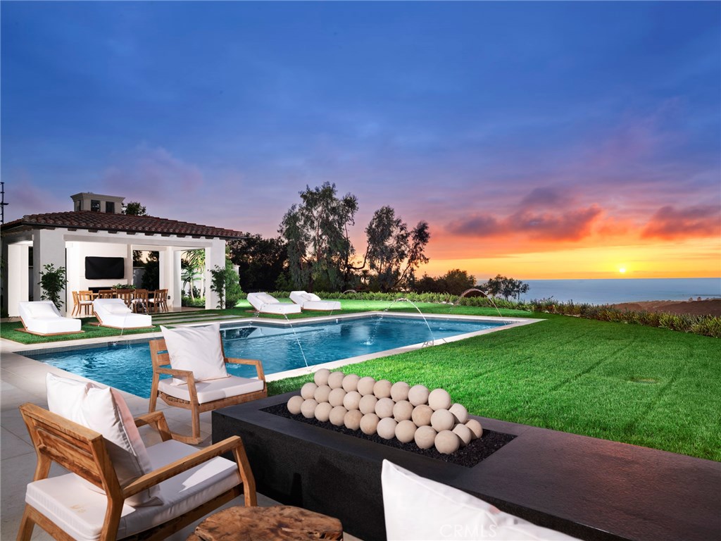21 Spinnaker is Crystal Cove’s next landmark residence, featuring the highest quality new construction and most sought after design in the region. The estate graces one of the best lots in the enclave, a prime oversized corner site (over 20,600 sf) on Crystal Cove’s smallest, quietest street — providing the most privacy and unobstructed views of ocean, coastline to Palos Verdes, harbor, and sunsets. The new 11,431 sf residence encompasses 5 bedrooms, 7.5 bathrooms with stunning European architecture by famed EBTA Architects. Sophisticated transitional interiors and an open concept floorplan span three levels of casually elegant living with seamless flow from one room to the next and through walls of automated disappearing doors to the sublime grounds. The attention to detail is astounding, with every handcrafted finish, imported material and curated amenity selected for long-lasting appeal and luxury. Dual master suites (one on first level) include a main master with breathtaking views, sitting room with fireplace, his and her spa bathrooms (both with steam showers + dressing rooms), and an expansive terrace. Other highlights: climate-controlled wine wall, large chef’s kitchen and secondary catering kitchen, lower level gym, bar and theater, saltwater pool + spa and pool pavilion, Control 4 home automation, security camera system, Vantage lighting, and an 8+ car subterranean garage.