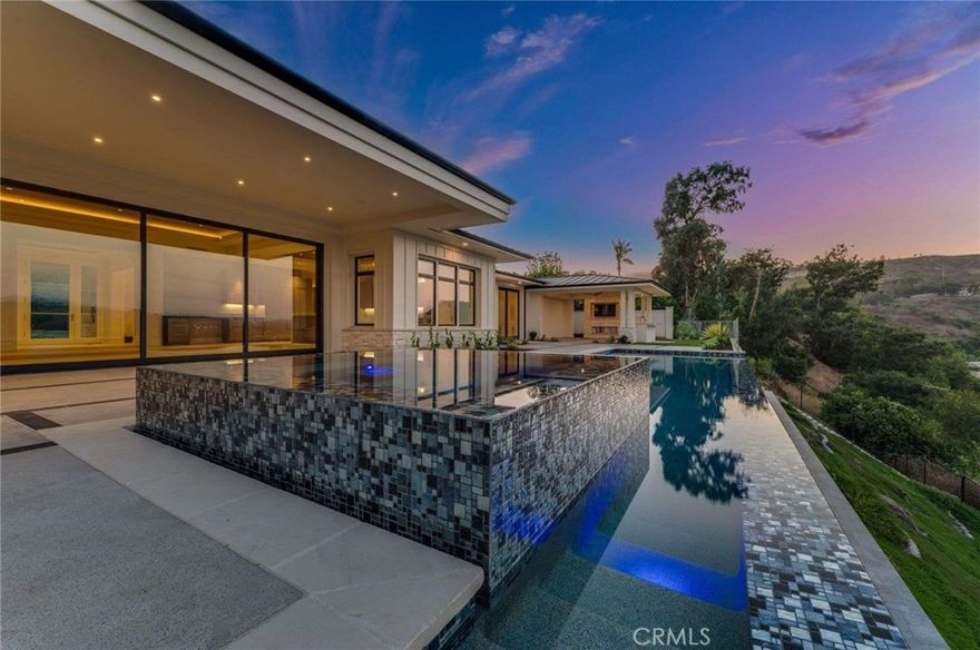 New Construction. Single story Contemporary Farmhouse designed home with sweeping views of the San Juan Valley, rolling hills and beyond plus the iconic San Juan Capistrano Mission. From the foyer forward you're drawn to the 180-degree view and the sight and sounds of a 32 by 13 infinity edge saltwater sports pool and spa. Step inside the natural light filled great room with a twelve-foot cedar wood ceiling that is anchored on one side with Wolf inspired gourmet kitchen including a massive Mt. Blanc waterfall edged Quartzite finished island and a grand floor to ceiling quartzite faced 72-inch Ortal gas fireplace on the other. Underfoot T/O the house are rich 9-inch wire brushed white oak engineered floors. Each room in the house including both the office (with built-ins) to the right of the entry and formal dining room to the left are filled with natural light emanating from Sierra Pacific custom windows and sliders throughout. There are 4 bedrooms each with unique ensuite baths including the primary bedroom which has its own 17 by 12 patio, and includes a stone walk-in shower, hydro standing tub and spacious walk-in closet. Elegant guest bath with floating back lite mirror. Remote controlled silent celling fans in each bedroom. Central air with 2 dual zoned condensers. Efficient electric central heat. Instant hot water at each faucet powered by a state-of-the-art tankless hot water system. Plumbed for central vac. Built-in speakers inside and out. Front yard completely enclosed and professionally landscaped with centrally controlled irrigation system, evening accent lighting and 4 mature olive trees professionally planted for a long life. The back yard is completely landscaped with an automatic irrigation system, accent lighting and enclosed on the bluff side with with a 100 foot 42 inch high and 1/2 inch thick tempered glass wall.  The inviting sport pool and spa are both salt water infused with vanishing infinity walls that disappear into the view. The California room on the west side of the rear yard opens to the view on two sides, enhanced with made for TV alcove, gas BBQ island with added sink and fridge with stone top prep area. Both open and covered lounging areas surround the pool and spa. Underground and below the foundation and pool are eighteen, 20-50 ft deep caissons for added peace of mind. Standing seam black metal roof w ridge venting and 50 year life. 3 car garage: one single and one double.