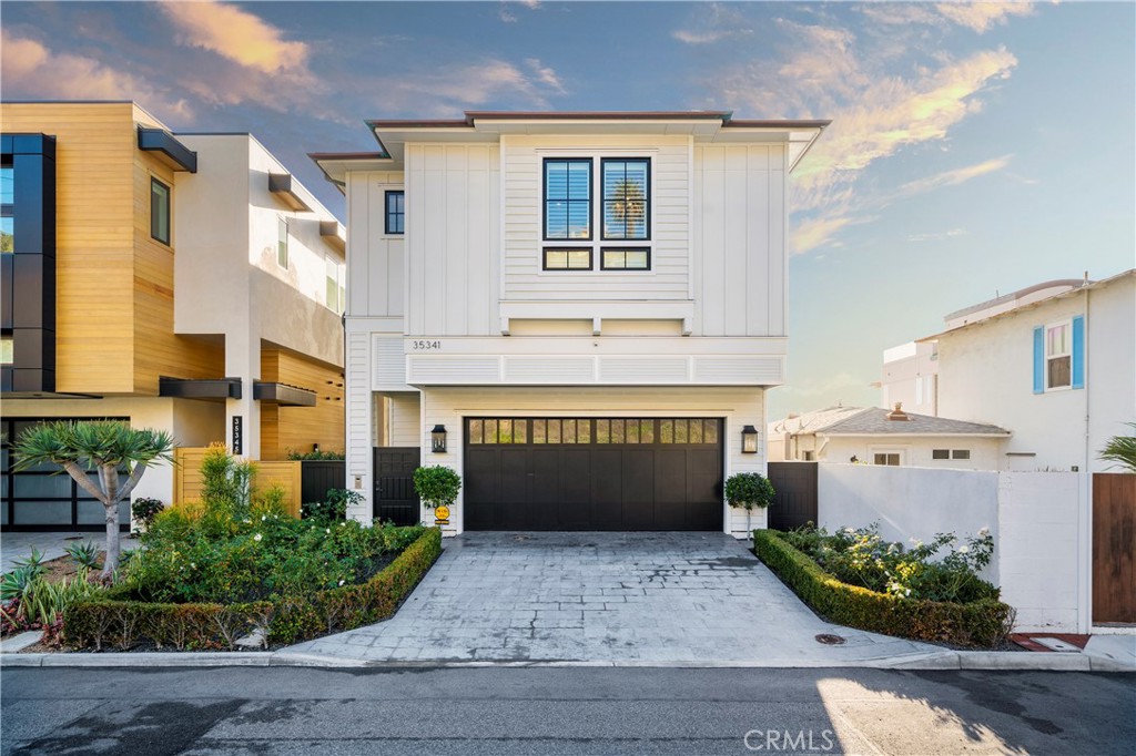 Your search for the ultimate oceanfront home has come to an end on guard-gated Beach Road in Capistrano Beach with this extraordinary custom residence designed by Jack Garland Architect. Known for their extraordinary homes, Mur-Sol Builders performed the construction on the project with Barclay Butera handling the exquisite interior design. Located on the sand, the open and bright design offers a front-row seat to priceless ocean, whitewater, beach and coastline views from both levels. The generously sized floorplan features five ensuite bedrooms, most with walk-in closets, six-and-one-half baths, an elevator, temperature-controlled wine room, dining room with wet bar, and a sunny great room with fireplace and slide-away doors to a beach-side patio. The residence was constructed on a state-of-the-art raised caisson foundation system to help manage the elements of living on the beach. No expense has been spared on designer-selected finishes and appointments, including extensive marble and stone, whole-house audio with high-end audio/video components, floating under-lit vanities, custom motorized window treatments, state-of-the-art Wi-Fi and technology, an attached two-car garage and three additional private parking spaces opposite the residence. Open to the great room and dining room, a chef’s kitchen with oversized island showcases bar seating, Calacatta marble countertops, custom cabinetry, and top-of-the-line Sub-Zero, Wolf and Asko appliances, including a dual-fuel six-burner range with pot filler. Panoramic Pacific vistas enrich the five-star primary suite, which is home to a fireplace-warmed sitting room, an outdoor balcony overlooking the beach, an enormous walk-in closet with dressing area, vaulted ceiling, sit-down vanity, and privacy glass that switches from clear to opaque with the flip of a switch. A seaside patio is ideal for entertaining, and a convenient mud room with bath offers outdoor access, making it the first stop for an after-swim shower. Coastal contemporary architecture is embellished with traditional-style siding. The homesite continues across the sand to the median high-tide line. This private community offers the perfect mix of exclusivity to attract those that just want to put their feet in the sand and own a unique piece of the California Coast.