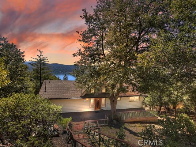 This is the lake view home you have been looking for. Open floorplan with big lake views as soon as you walk in the front door. High vaulted ceilings and fireplace in living room which opens to dining room and kitchen. Two bedrooms, full bath and separate half bath on main level. Two sliders open out to large viewing deck to enjoy the sun and mountain air while taking in the lake views. Downstairs you will find two beds and two baths although the large bedroom is currently configured as family room with pool table. House needs some TLC but is priced accordingly. This is a legitimate lake view, not a peek-a-boo view so don't miss out. Put some elbow grease into the property and you'll have a great family retreat for years.