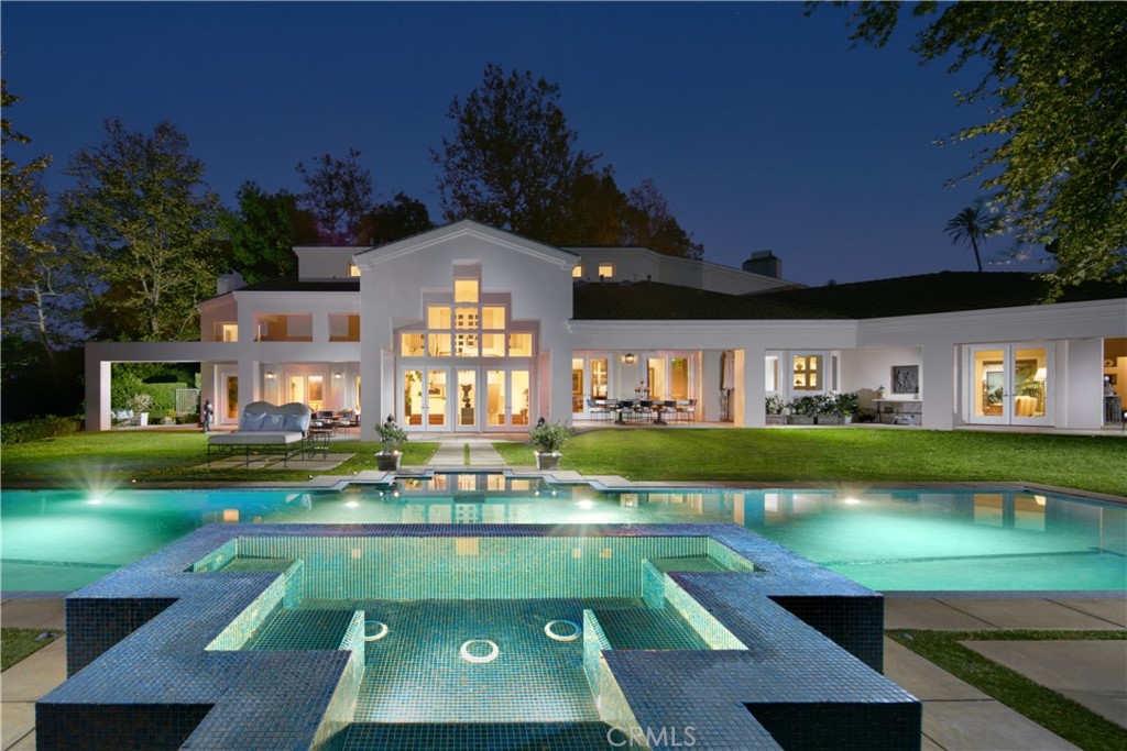 A one-of-a-kind legacy estate set on a roughly five-acre lot behind the exclusive guarded gates of the Hunt Club in San Juan Capistrano. Commanding majestic views of the hills below, the stately residence is introduced by a tree-lined private gated driveway. Enclosed within, a full suite of stellar amenities, including a step-down wine cellar and a detached two-bedroom guest house perfect for extended family or overnight guests. Designed by architect Gilbert Aja and remodeled by master builder Tony Valentine, the six-bedroom home hosts artisanal touches and striking elements that include custom moldings and millwork, impressive ceiling beams, recessed wall niches, wood flooring, skylights and tray ceilings. The entry level is dedicated to two sumptuous ensuite bedrooms with walk-in closets, a fireplace-warmed library, and an elegant primary suite that reveals an enormous spa-inspired bath with a shell-shaped walk-in shower, a seating area, dual-sided fireplace, two oversized walk-in closets including one with cedar lining and a large center island, and a private balcony that takes full advantage of awe-inspiring vistas. Downstairs, the gourmet kitchen impresses with a commercial-grade 12-burner cooktop, two Wolf convection ovens, a Sub-Zero refrigerator, warming ovens, two Bosch dishwashers, and a butler’s pantry with a built-in coffee maker. Two opulent living rooms, a formal dining room, laundry room, office, and an ensuite bedroom with access to the serene backyard round out the lower level. The property's grounds offer a hedge-lined staircase that leads to an upper-level open space that is a great venue for entertaining and showcases a lawn, large-scale fire pit, built-in BBQ and ample seating. Enjoy covered patios with sweeping hill views, a saltwater pool and spa, water features and built-in heaters. Presenting approximately 176 feet of view frontage overlooking verdant valleys, Hunt Club community, and Marbella Country Club, the residence’s desirable privacy and tranquility belie its location just minutes from trails, shopping, dining and beaches.