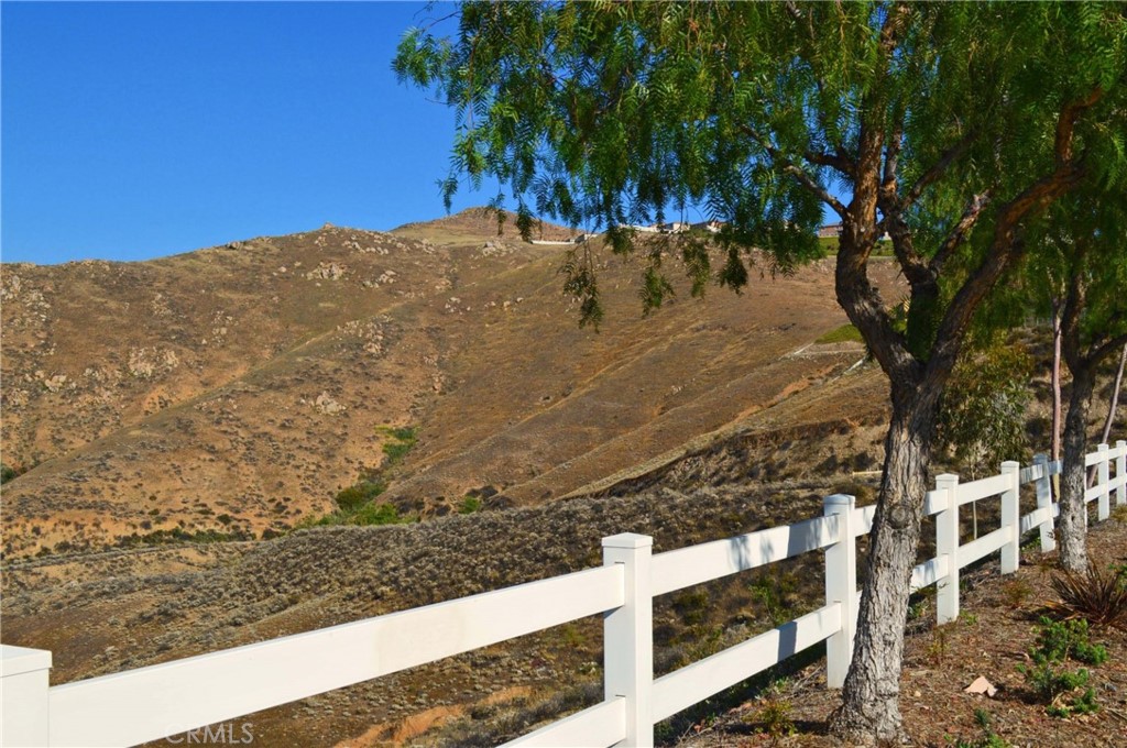 Rolling undeveloped terrain with amazing views adjacent to newer high-end homes in the Lake Hills area. Located in the County of Riverside outside Riverside City limits. County zoning on these 6+ acres allows limited uses such as a child daycare center or non-commercial community association recreation and assembly buildings. With a conditional use permit, zoning may also allow a church. Sorry but zoning does not allow houses, condos, townhouses, manufactured homes, tiny homes, RVs, or commercial uses. Beyond this, the agent and seller have no additional information on allowed uses. If this area is ever incorporated into the City of Riverside, which may or may not happen, zoning could change. At this time, buyers will want to direct all questions about zoning and land use to the Riverside County Planning Department, not to the listing agent. District water, sewer, and electricity are in the paved street. Great opportunity for a savvy long-term investor who thinks out of the box!