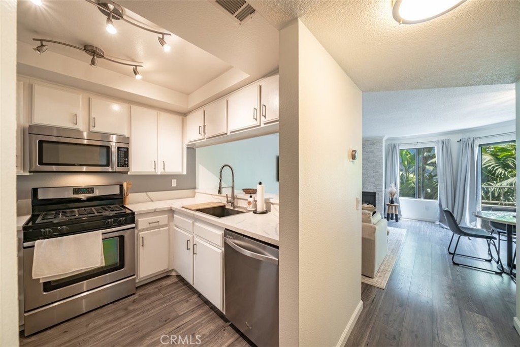 Welcome to your beautifully remodeled, move-in ready condo nestled in the heart of Long Beach's vibrant Alamitos Beach neighborhood. This charming 1-bedroom, 1-bathroom condo has been thoughtfully upgraded to offer modern comfort and style. Step inside to discover new floors that flow seamlessly throughout the open living space. The remodeled bathroom boasts contemporary fixtures and finishes, while the kitchen features stunning new countertops perfect for meal prep and entertaining. Cozy up by the redone fireplace, and admire the elegant crown molding that adds a touch of sophistication to each room. Stay comfortable year-round with the newly installed AC system. This condo is conveniently located within walking distance to the lively 4th St Corridor, where you'll find endless options of boutique shops, charming cafes, dining, and entertainment. HOA includes water and trash. Don't miss out on the opportunity to call this beautiful condo your home. Experience the best of Alamitos Beach living with all the modern upgrades you desire!