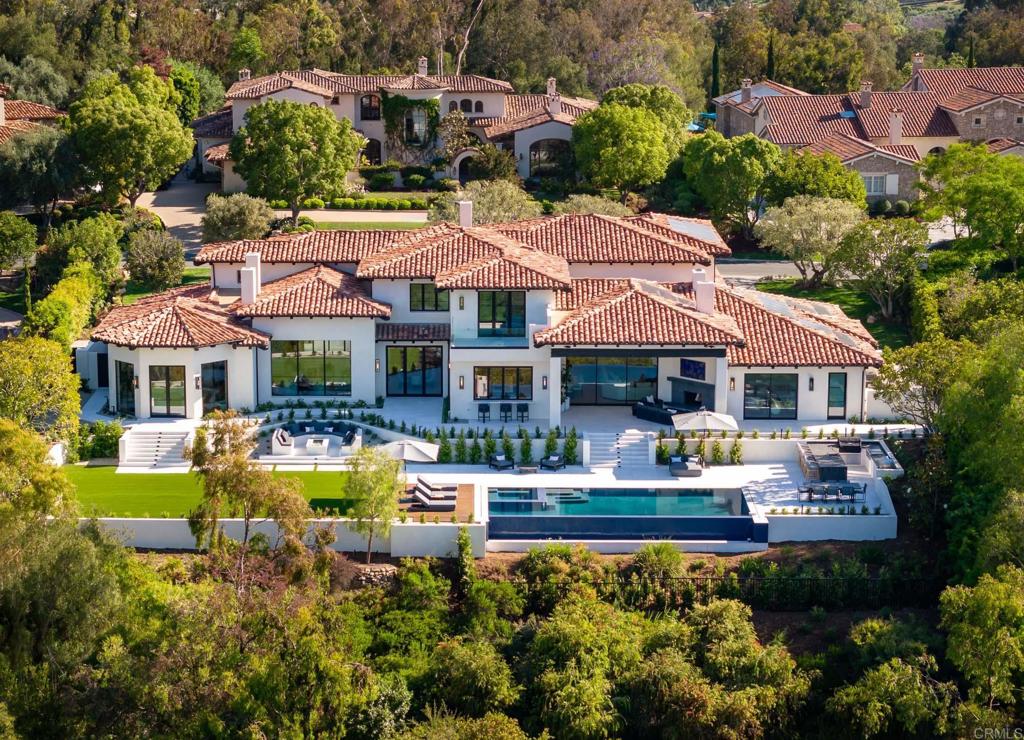 Newly Rebuilt/Renovated in 2023, Bridges Estate masterpiece. Uniquely positioned with exceptional views of both the 1st and 18th fairways of the Bridges at Rancho Santa Fe. This brand new custom home showcases impeccable design by renowned architect Mark Radford and builder, Josh Herbst. Property is also located within the prestigious Roger Rowe School District. From the moment you enter, you'll be captivated by the attention to detail and the seamless blend of high-end finishes with an abundance of natural light. The home features a well appointed redesigned gourmet kitchen with a pass-through window, as well as a new prep kitchen for your culinary adventures. Experience one-of-a-kind views from the main floor primary suite with separate walk in closets, two private water closets, and two showers: one inside and one outside for a tropical experience. Additionally, the lower wing of the house has been transformed to include a light-filled laundry room and an attached guest casita with either a 2 bedroom, or 1 bedroom with an expanded living space. It also features its own separate entrance, complete with setup for a separate stackable washer and dryer. Enjoy indoor-outdoor living at its finest, allowing you to bask in the ultimate California lifestyle. Step outside to the resort-like backyard, where a covered loggia overlooks the infinity-edge pool offering breathtaking views of The Bridges golf course, main clubhouse, lake and bridge. The landscaping has been meticulously expanded, creating a backyard paradise complete with outdoor kitchen, fire pit and pizza oven. Whether you're hosting a poolside soiree or enjoying a quiet evening under the stars, this outdoor oasis is designed to fulfill your every desire. All new appliances, windows, doors, plumbing and electrical fixtures, exterior finishes, new roof, and new solar all insure that modern convenience and efficiency are at your fingertips. Other highlights include a climate controlled wine room, built-in BBQ, gorgeous curved wrought iron staircase, a four car garage and numerous archways that add an extra touch of elegance to this already exceptional property. Don't miss this opportunity to experience the epitome of fine living in The Bridges. Move-in ready, this home is truly a work of art.