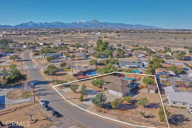 Southwest Hesperia home close to I-15 Freeway with RV/boat parking. This is a custom built home. It was constructed with 2 X 6's NOT 2 X 4's throughout. Large lot with multiple gates, 3 car garage is oversized with 667 sq. ft. and has 9 foot ceiling and has 220V / 50-amp service (2 garage door openers). Plus there's an additional place for a car or boat in the 240 sq. ft. shed on the side lot. It's built on a concrete slab and has an entrance gate from the street. 3 bedrooms plus an office, two full bathrooms, large sunken living room with warm fireplace, large tile floors, large kitchen with tons of storage, massive covered patio that spans the full length of the house, multiple mature trees, pool, storage shed, extended concrete, beautiful low water usage landscaping and much more! Close to shopping, schools, and the NEW Ranchero Road I-15 off/on ramp. Pride of ownership is easy to see with this quality home! Association Amenities: None # of RV Spaces: 0 Special Features: BN,,PTRY,SH,WKNONE Lot Location Type: Standard Location Special Features: Garage Door Opener # of Attached Spaces: 3 # of Detached Spaces: 0