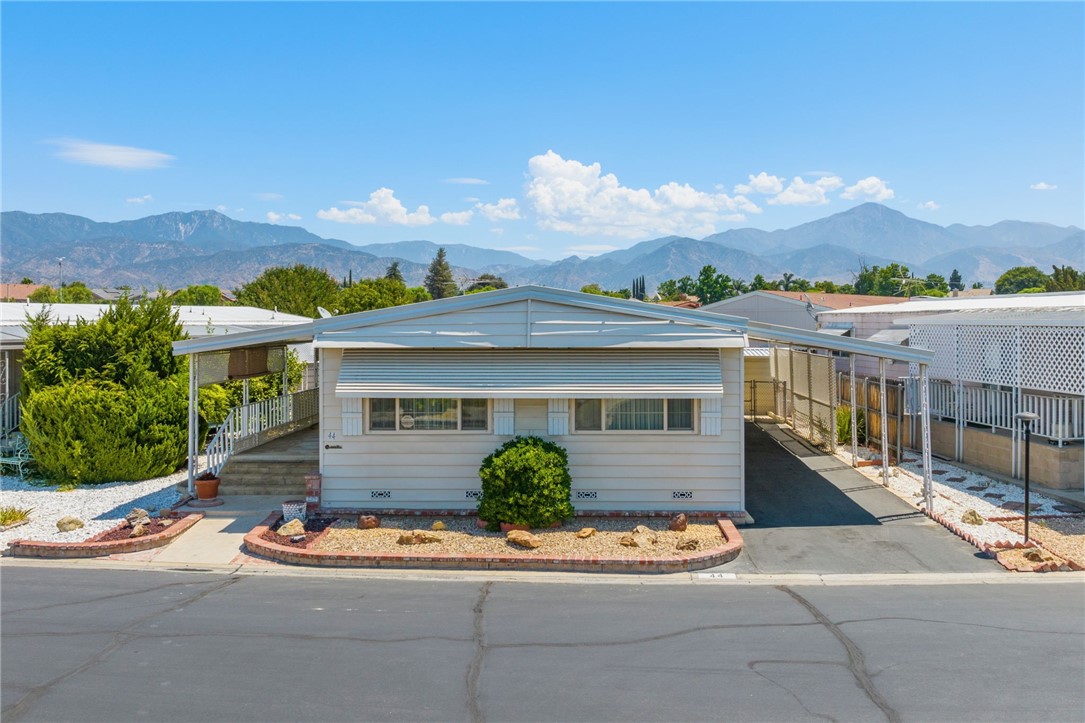 Welcome to the fabulous senior community of Lugonia Fountains, where this well-maintained manufactured home awaits its new owner. This lovely 2-bedroom, 2-bath residence spans ~ 1,536 square feet. With only 1 OWNER, you can be assured that it has been cherished and cared for over the years. As you approach the home, you'll be greeted by its charming curb appeal, which sets the tone for the delightful interior that lies within. A carport for 2 cars provides convenient parking, & a porch invites you to relax and enjoy the serene surroundings. NEW WINDOWS THROUGHOUT,& also 2 sheds for additional storage, perfect for keeping your belongings organized and tidy. Step inside, & you'll find a home designed for comfort and functionality. The spacious living room features a CEILING FAN & lots of windows. Adjacent to the living room, the dining area boasts a mirrored built-in hutch, ideal for storing kitchen gadgets & displaying your finest china.The heart of the home is the kitchen, featuring white cabinets, tiled floors, & an open layout that connects seamlessly w/ the family room. The kitchen is equipped w/ all the essentials & INCLUDES the REFRIGERATOR. The family room comes w/ built-in shelves & storage, providing plenty of space for your entertainment needs.The secondary bedroom is a comfortable retreat with a ceiling fan and a large closet. It's conveniently located near the secondary bath, complete with a bathtub for relaxation and convenience. The primary bedroom is generously sized, featuring large windows that allow NATURAL LIGHT to fill the space. A ceiling fan keeps the room comfortable, and a walk-in closet offers ample storage. The en-suite bath is well-appointed with dual sinks, a vanity, a walk-in shower, and plenty of storage space.The laundry room is equipped with a WASHER and DRYER SET, and it offers direct access to the side yard and carport for added convenience. Tie down earthquake straps 4 extra protection and double roofing for extra insulation are 2 additional perks. In addition to the wonderful features of the home, Lugonia Fountains is a 55+ community that offers an array of amenities to its residents. Enjoy access to a POOL, SPA, billiard's room, and a clubhouse with various activities. The community is centrally located, providing easy access to shopping, restaurants, and major freeways. This charming manufactured home presents an excellent opportunity to enjoy the comforts of senior living in a well-maintained and friendly community.
