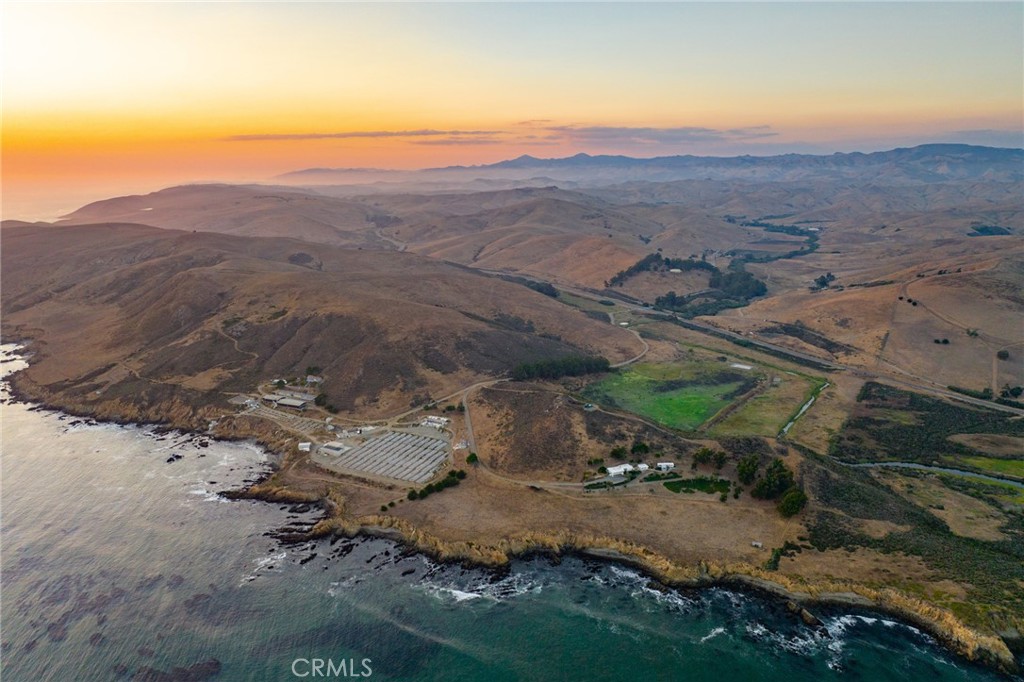 Alexander Ranch is a stunning, oceanfront/coastal ranch of over 357 acres located between Cayucos and the small Community of Harmony. The ranch is bisected by Highway 1 and features a northerly/ inland portion with 195± acres and a southerly/coastal portion comprising 162.41± acres that includes extensive coastal frontage. An extraordinary property that presents a setting unlike any other with extensive ocean frontage, proximity to Cayucos, usable terrain, creeks, spectacular coastal views, and southerly orientation. The ranch features a main, single-family residence with shoreline views and several mobile home farmsteads with multiple miscellaneous buildings. The elegantly appointed main residence features over 2,295± sq. ft. of direct ocean views offering the perfect blend of classic comfort and modern living. Complete with 2 bedrooms, 2.5 bathrooms, basement, attached carport that holds up to 3 vehicles and a detached studio/workshop. The generous acreage also features substantial improvements and facilities comprising an extensive abalone farm and facilities on 16± acres leased for 30 years at $61,200 per quarter. In addition to the abalone farming, this property has historically been operated as a livestock ranch. Due to the predominant open grass, mild climate and water conditions, this ranch is well-suited to livestock production with a set of corrals located near the main gate. The inland ranch portion is located outside the coastal zone jurisdictions which allows for potential future development. Elevated coastal living awaits you with unobstructed ocean views and the natural splendor of the generous acreage.