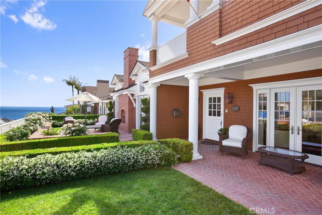 Immaculate and highly upgraded Nantucket-style home located in the exclusive Flower Streets of Corona Del Mar boasts sweeping ocean, harbor and Catalina views. Home is situated on a double lot, with approximately 60 feet of frontage. 5 bedrooms, 6.5 baths plus Gentleman's office, subterranean bonus room and gym/nanny's quarters/or 6th bdrm. Highest grade finishes include an abundance of crown moldings, paneled walls, built-ins, wainscoting, quarter sawn white oak floors in rich walnut finish, designer wall paper, and 5 fireplaces. Gourmet's kitchen is equipped with a Viking range, Subzero refrigerator, Shaw sinks, Waterworks faucets, marble backsplash, large center island with barstool seating and a built-in dining nook. Additional features include a 300 bottle wine room, front patio with cozy fireplace, 3 car garage with epoxy floors, rooftop deck with impressive panoramic views, central courtyard with spa and grass area. This stunning property is the ultimate entertainer's dream home!