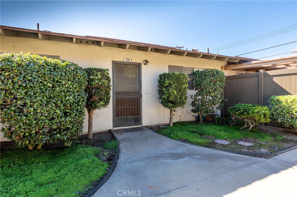 Come see how this peaceful, pet-friendly sanctuary in the heart of Orange offers an open feel and a blank canvas for you to make your mark on. Its central location with easy access to the 22, 55, and 57 freeways make it perfect for commuters away from the chaos of nearby cities. This single story, 2 bedroom 2 bathroom condo is equipped with bar seating, a spacious living room with wood burning fireplace, and large sliding glass doors to the outdoor lounge area, making it wonderful for hosting gatherings. A covered patio with skylights provides cool, natural light and the tall fence in the backyard adds privacy, making this property feel intimate and tranquil. Vintage stove, ample cabinet and counter space, and adorable floral wallpaper give the kitchen modern practicality with retro style. Its location near Chapman University, Old Towne Orange, various nearby parks and proximity to shopping malls, restaurants, and hospitals also make this neighborhood great. Abundant storage in both of the bedrooms and hallway allow you to transition easily and keep a clean look to your space. This safe, gated community that was remodeled within the last 4 years also gives you access to a clubhouse/meeting room available for reservation as well as a pool to enjoy.
