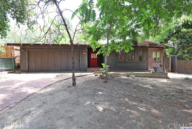 Calling all Investors, developers or owner occupants looking for something truly special to bring back to life and make their own! Don't miss out on this 2-unit Craftsman architectural beauty w/ unbelievable potential just waiting to be lovingly restored! This estate-like two on a lot sits back from the tree lined street, located in the prime pocket north of York in Eagle Rock. A long driveway & attached 2-car garage welcome you inside. The spacious interior of the main house features ample spacing & architectural details drenched in natural light; thus an open floor plan can yield innovative use of space & great designs. The living room features a brick fireplace while the den boasts high ceilings & large windows. Several access points lead to the brick courtyard outside or spacious backyard. With the large lot, there's enough room for a pool & then some in this entertainer's dream. The detached rear cottage is a great opportunity to fix up & rent out, featuring a living room, fireplace, full kitchen, laundry area, & spacious bed & bathroom! The neighborhood is picturesque, prime, & highly desired, w/ conveniences, restaurants, shops, & schools within a stone's throw. Bring your tool belt and imagination for, this Eagle Rock gem is too good to pass up!