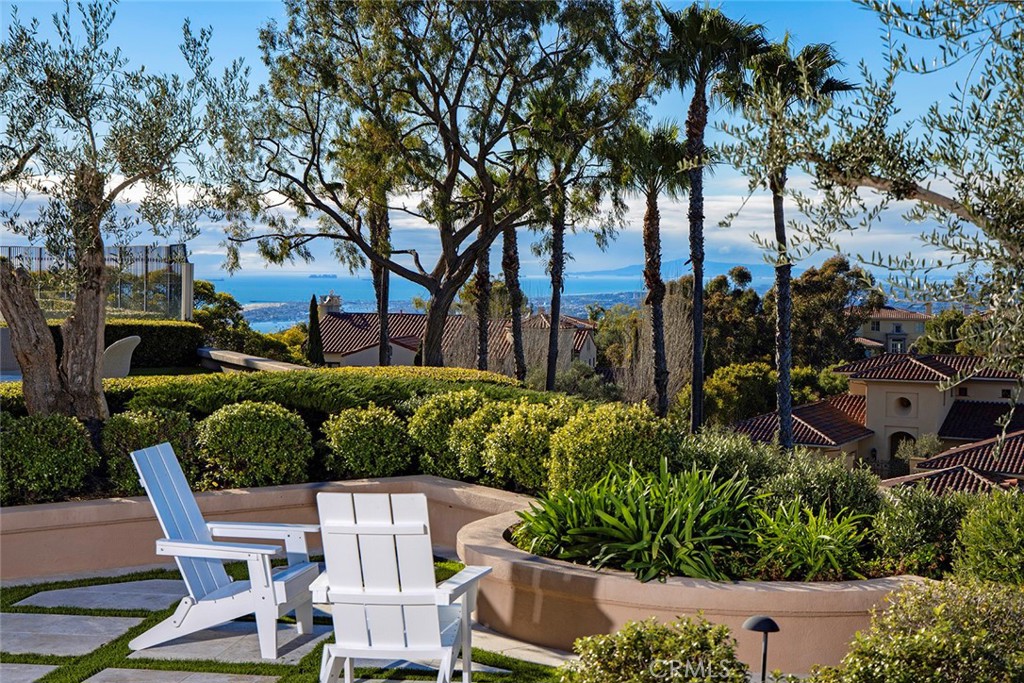 This extraordinary and rare single level property in the highly sought-after guard-gated community of Pelican Ridge, Newport Coast. This exquisite residence offers a rare opportunity to experience coastal living at its finest with the communities added layer of privacy and tranquility. With 4 spacious bedrooms (one currently converted into an office suite), 4.5 luxurious bathrooms, and an open, sunlit floor plan with soaring ceiling heights, this home provides a versatile canvas for your personalized design vision. The property hosts light bright communal living areas centered around fireplaces and exquisite woodwork, a chef's dream kitchen, formal dining room open to front courtyard melding the interiors with the exterior grounds, oversized garage with ample storage, and a primary bedroom retreat reminiscent of the finest coastal resorts showcasing extraordinary vistas. Awe-inspiring canyon-to-Pacific Ocean with city lights views await from the comfort of your expansive lanais, where you can relish every sunset and create cherished memories. The mature, enchanting hardscape and landscapes add to the property's allure. Located in a neighborhood that boasts 24-hour security and patrols, this residence is your invitation to coastal bliss, ready for your personal touch and endless design possibilities. Don't miss this chance to own a piece of the coastal dream in Pelican Ridge.