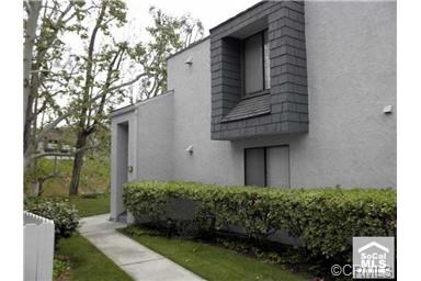 Lower level end unit with 2 bedrooms and 2 bathrooms located on either side of living room. Home will be freshly painted. Newer tile floor in living room and dining room with newer carpet in bedrooms only. Remodeled kitchen with granite counters, built in microwave and dishwasher.. View from both bedrooms and living room. Mirrored wardrobes in both bedrooms. Inside laundry with stacked washer dryer. Large balcony off living room with large storage closet. Additional storage in carport area and just outside front door. Grassy area just outside front door. Community pool and laundry room.