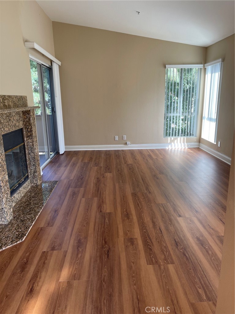 The 'Hills' where nature is abundant & right outside your front door. Brand new laminate flooring in the living room, dining room and hallway. This condo has 2 beds Rms/2 bath Rms, 1252 sq. ft. of living space plus a large wraparound rear patio for those tenants that want space, privacy, and relaxation all in one location. As you enter the first thing, you'll notice is the high cathedral ceilings and as you meander into the home you will notice the open living room with fireplace that opens to the formal dining room. The dining room has a beautiful built-in hutch with under cabinet lighting where entertaining your guests will not only be enjoyable, but memorable. Both bedrooms offer great space and walk-in closets. The kitchen is gorgeously upgraded with custom maple cabinets, black granite counter tops, stainless steel appliances, custom plate rack, pull out ironing board, spice rack, trash receptacle and much more. The slider off the kitchen opens onto your warp-around patio that’s a perfect place to entertain your family and friends or just to enjoy that morning cup of coffee. Enclosed walk-in laundry area off warp- around porch and storage area off the front entry. Highly sought-after school district and part of the newer Yorba Linda High School that's much in demand. The HOA amenities offer; clubhouse, dual lounge areas, gym, 2 pools/2 spas, tot lot play area & a regulation tennis court! This home has been tastefully remodeled and waiting for that new tenant to call it home!