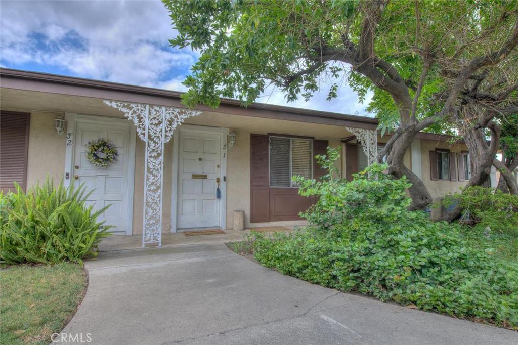 Fantastic opportunity to own this single level end unit with only one shared wall. This unit offers an open concept floor plan, with the largest patio in the complex for entertaining. The spacious living room comes with a one of a kind wood burning fireplace with mantle for those cold winter nights. The dining area opens to the beautifully upgraded kitchen, with newer cabinets and granite counter tops. Kitchen appliances include microwave, stove and dishwasher. There are 2 spacious bedrooms and 2 fully updated bathrooms with tile floors in kitchen and dining room. This unit also offers central air/heating. Find cordless blinds throughout and all plumbing under kitchen and bathroom sinks have recently been updated. The water heater, furnace, a/c unit and garbage disposal are all newer. Located in the Orange Unified School District in the heart of Orange County with easy access to shops, restaurants and 55/91/57 and 22 fwys. Don't let this opportunity pass.