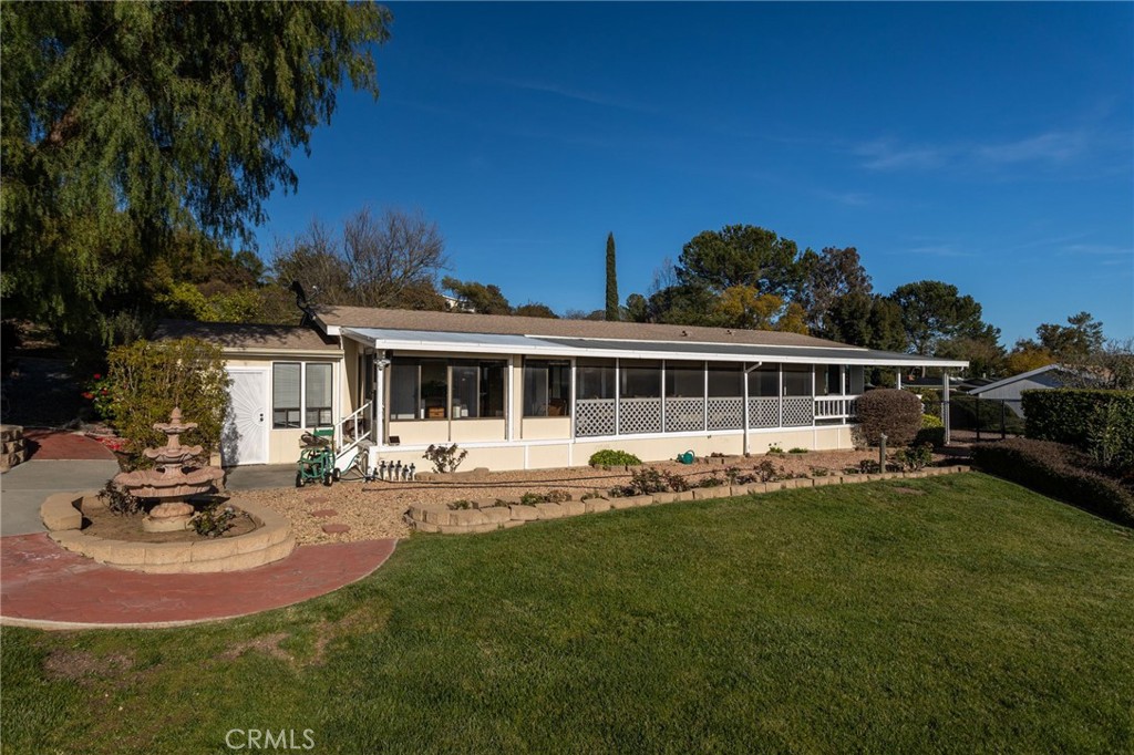 WELCOME HOME!! THIS 1980 MANUFACTURED HOME IS BEAUTIFUL, MOVE-IN READY WITH ENDLESS SUNSET VIEWS!!- This 2 bedroom, 2 bathroom home sits on one of the largest lots in the park, with some of the most amazing views. A spacious back room provides ample storage and is the ideal craft room or workshop. The possibilities are endless Enjoy the most spectacular sunsets from your screened in porch. The yard is private, maintained and has mature avocado, orange and lemon trees! Skyline Ranch Country Club is a premier Senior Park that boasts an exclusive SCGA rated golf course. GOLF IS INCLUDED IN THE LAND LEASE! This property is a must see!