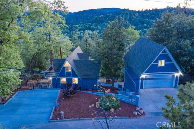 A-frame w/lake rights located in Arrowhead Woods. Not just the ultimate lakeside getaway,this rare find offers a bonus guesthouse-perfect for rental income or an in-law suite. Nestled among mature trees,you're just a few minutes from the lake where you will enjoy countless hours of water fun! Plus, w/an oversized garage & 2 large car pads, you'll have plenty of space to host. Natural light fills the space and highlights the soaring ceilings, designer flooring and high-end finishes. The gourmet kitchen offers custom cabinetry, top-of-the-line appliances & luxe quartz countertops w/bonus breakfast bar seating. Outside an oversized deck has breathtaking views,spacious bedrooms & baths, 2 master suites. Recessed lighting, walk-in closets & spa-like bathrooms. The cherry on top is the 450 sq. ft. studio guest home has also been renovated with all the comforts & including a full kitchen, bath and spacious porch.Schedule your private showing!