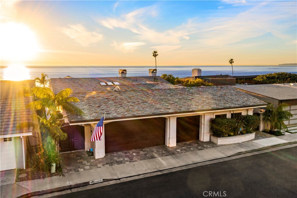 Poised on one of the most coveted ocean view streets in San Clemente, this immaculate, contemporary style residence combines coastal living and custom home elegance. Truly a rare opportunity to purchase a turn key property behind the prestigious Cyprus Shores gates with jaw dropping ocean views. The split level, open concept floorpan offers 4 bedrooms, 5 bathrooms, two spacious family rooms, a gourmet Kitchen, office, courtyard, and stunning backyard all overlooking the Pacific Ocean. Dazzled with many windows and west facing doors, the natural light and sea breeze spills in from morning to evening. Step onto beautiful stone floors and admire the completely remodeled home with Mahogany post and beam ceilings, custom lighting, and multiple sky lights. The Kitchen is complete with top of the line Thermador and Wolf appliances, lots of storage, and a large Kitchen Island with sitting opening up to the spacious Living Room. Stare down the coastline from the handsome Master Suite featuring custom built ins, access to the balcony, impressive walk in closet, and beautiful Master Bathroom with a soaking tub and walk in shower. An additional ensuite bedroom is on the main level. Head downstairs to find an additional Family Room/Bonus Room as well as two en suite bedrooms and a nice backyard area with an above ground jacuzzi. The pristine three car garage offers custom built ins and racks as well as a full office build out. The house is located just steps away from the private beach Cottons Point as well as North Gate, the community pool and spa, clubhouse, park, and tennis courts. Only a few minutes bike ride to world renowned surfing at Trestles, and an easy golf cart ride to charming downtown San Clemente. You do not want to miss an opportunity to own such a premier property!