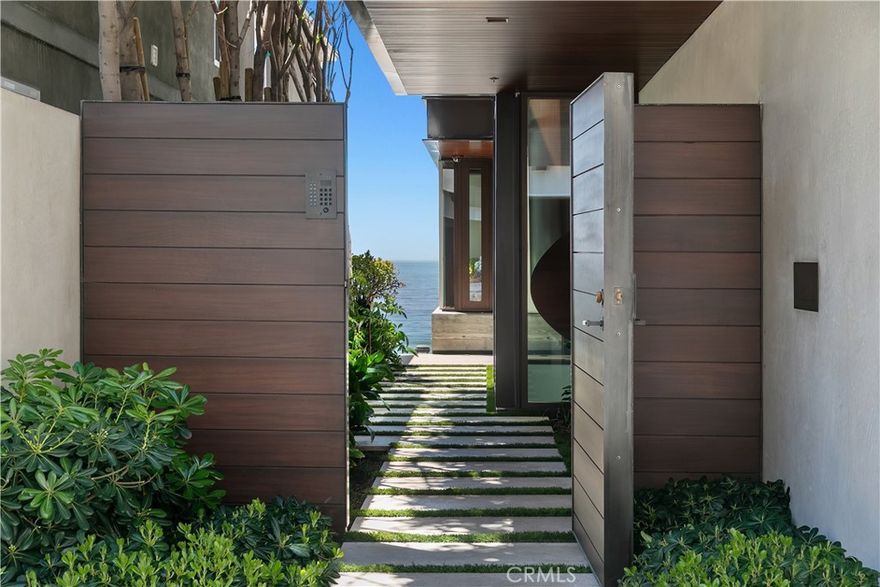 We proudly present one of the finest homes ever built in Manhattan Beach. A masterpiece designed by KAA Design and built by Matt Morris Development. This magnificent property stands proudly on the Manhattan Beach Strand overlooking one of the most prestigious beaches in the world with panoramic views from Palos Verdes to Malibu. You are met at the entrance with a Mahogany-clad circular staircase connecting the middle-level entry with the top floor living space. Four levels of soaring 10-foot ceilings and floor-to-ceiling windows and doors flood the house with natural light The top floor outdoor living and dining area enjoys spectacular views and privacy from the beach below. Bronze folding louvered panels can be opened or closed to control light or protect the space from the elements. On the west side of the property, the beach room features an impressive bar with bronze shelving, a lounge area, and a pool table. On the east side of this level, you will find a fully equipped gym and spa oasis not often found in a private residence. Below this level is the home theatre along with another living area, a wine cellar, and a tasting room. A stunning beachfront facade is arranged around four two-story Mahogany "masts" maintaining the ocean views but allowing for interior privacy for the midlevel master suite and boardwalk level beach room. This exquisite home exudes luxury, discerning taste, and offers unmatched premium Strand living with privacy unlike any other.