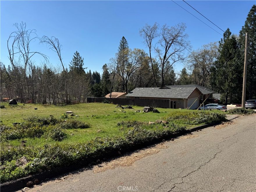 Nestled in the peaceful community of Magalia, this property sits within the Paradise Pines Property Owners Association, offering access to a clubhouse, swimming pool, tennis courts, walking trails, and more. Surrounded by tall trees and well-established homes, the setting provides a welcoming feel and a great foundation for your future plans. Outdoor enthusiasts will love the nearby hiking trails, while convenient shopping and dining options are just minutes away. Previously home to a two-bedroom residence, the property benefits from Del Oro water service and prior power connections, making it well-positioned for your new home.