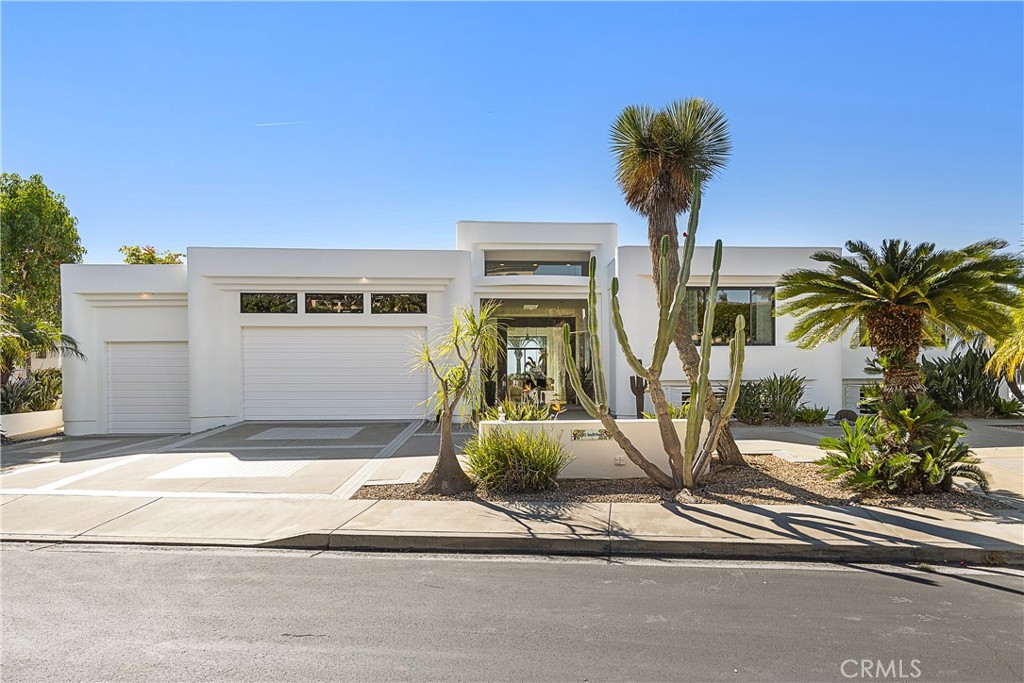 HUGE Price Reduction! This stunning residence in the sought-after gated community of South Peak offers a unique opportunity for car enthusiasts and those who appreciate innovative modern architecture. The property boasts a sprawling subterranean garage with space for over 10 cars, making it a true car collector's residence. The single-story home features custom architecture designed by the owner in the late 80s, showcasing clean lines and large open spaces that were ahead of their time. The upper level is bathed in natural light, thanks to expansive floor-to-ceiling windows and skylights, offering breathtaking views of lush greenery and the ocean. The wide-open rooms with high ceilings provide the perfect canvas for showcasing large-scale artwork, creating a modern and organic living space. With four spacious ensuite bedrooms, a private yoga/meditation room, and a workshop, this home offers both luxury and functionality. The game room includes a mini basketball court which can be converted to additional parking. There are two full baths downstairs. The large saltwater waterfall pool and spa, along with the expansive entertaining decks, provide the ideal setting for outdoor relaxation and enjoyment of ocean views. The property's European custom original kitchen overlooks the pool and ocean, creating a captivating backdrop for everyday living. Sliding doors throughout the house seamlessly blend indoor and outdoor living, enhancing the overall sense of space and connection to the natural surroundings. Situated on a 10,800 square foot lot on a cul-de-sac, this residence is a rare find in the South Peak community. Close to El Niguel Country Club, Waldorf Astoria, Ritz Carlton, Salt Creek Beach, and Dana Point Harbor, the location offers a perfect balance of privacy and accessibility to premier amenities. This home, designed, built and owned by the same family for over three decades, is now available for the first time on the market. Don't miss the opportunity to experience the abundant space downstairs and envision the endless possibilities that this remarkable property offers. Embrace the opportunity to make this unique residence your own and live in a place where it feels like a permanent vacation. Opportunities like this are rare, so schedule a showing today and seize the chance to call this extraordinary property "home."