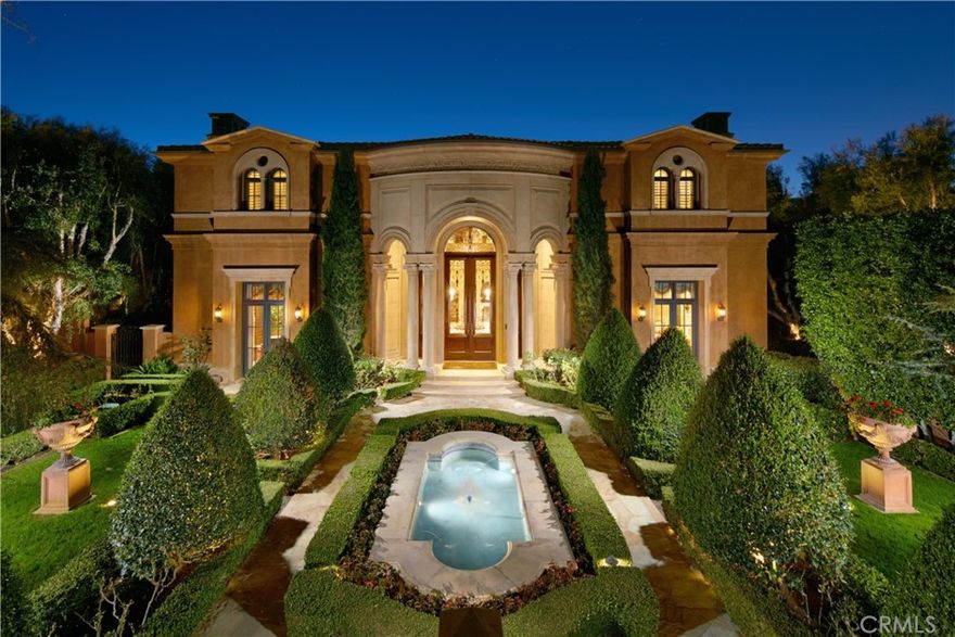 An enchanting palatial estate behind the guarded gates of Pelican Crest. Reminiscent of an Italian villa, the five-bedroom residence is set on an appx. 300' deep parcel over 29,800 square feet affording unique privacy and extraordinary ocean, city, and Newport Harbor views. Enter through a gated whimsical garden featuring mature plantings, a soaring columned front entry, and stunning tuscan-style fountain. The stately interiors exude romantic details such as a polychromatic hand-painted Florentine-style dome accentuated by a Dennis & Leen rock crystal chandelier, floors inlayed in Italian limestone, venetian plaster walls, cast stone niches, solid mahogany entry doors to the library and living room, inlayed oak floors, and hand-carved Italian marble fireplace mantels. Exemplifying refined grandeur, the home is introduced by a dramatic double groin vaulted hall with checkerboard-style granite and limestone flooring and a solarium highlighted by a hand-carved Italian fountain that leads to one of three loggias. The reception rooms are scaled for entertaining. Among them, a living room upholstered in Italian silk strie and a formal dining room embellished in hand-glazed coffered ceilings, a crystal chandelier, and wool and silk damask wall coverings. The intimate family room is serviced by a built-in bar and features beamed ceilings, a wall of retractable leather books concealing television, and five sets of French doors opening onto two large loggias with a Formations fireplace mantel. Satisfying modern tastes, the chef's kitchen is accoutered with French limestone floors, quartzite counters, and a farmhouse-style sink. Equally impressive, the fully-paneled library offers redwood burl panels, private entrance to a powder room, hand-carved 22k chandelier, and French doors that open to a loggia. The fireplace-warmed primary suite occupies a separate wing of the second level and hosts upholstered walls, custom millwork, a private covered terrace overlooking the blue water vistas, large walk-in closet, and spa-like bath outfitted in Calacatta marble. The lower level is dedicated to a subterranean garage, bar servicing a billiards room with wood flooring and limestone walls, dry sauna, and theater. Additional highlights include an elevator, paneled walls, and hand-glazed pilasters. Near world-class dining, shopping, entertainment, and dressed with every amenity imaginable, this exceptional abode is the epitome of timeless elegance.