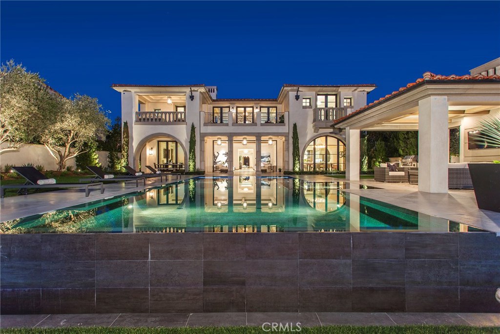 Bask in the elegance and luxury of quintessential coastal living within this brand new custom Crystal Cove estate located off the coveted High Water street. With views as far as the eye can see of the Pacific coastline, sunsets over Catalina, and Newport Harbor, this estate offers everything one would want from a seaside abode. The recently completed transitional style estate lends itself to a vast 12,352 square feet of living space on a 20,537-square foot parcel with 6 bedroom suites, 7 full bathrooms, 2 powder rooms, wine cellar and full glass wall display, home theater, elevator to all three levels, open air atrium, subterranean garage, library/ office, and powered pocketing doors that lead you out to the ocean facing back yard. Once outside in the back drop of the endless Pacific Ocean with Catalina island resting on the horizon, you can indulge in the vast amenities which include, custom 360 degree Infiniti edge pool, BBQ pavilion, and outdoor cabana with fireplace and TV, large fire pit viewing area all surrounded by well-appointed hardscape and landscapes. No detail was left unattended to, from the hand carved marble fireplaces, to the venetian plaster that coats the interior and custom millworks throughout. 17 High Water is the epitome of value and luxury within Newport Coast.
