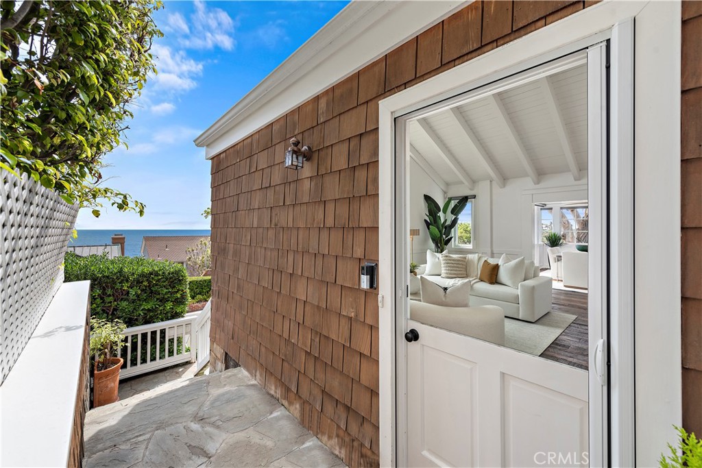 Experience beach living in this stunning Hamptons-style home, situated in the coveted Woods Cove of Laguna Beach with ocean and Catalina views. Some features include hardwood flooring, cathedral vaulted ceilings, oversized windows, and French doors.
The main level is designed for entertaining and has a gourmet kitchen equipped stainless steel appliances and plenty of storage. The dining area opens up to the adjoining balcony, which also presents captivating sunset vistas.
As you step into the spacious formal living room, your gaze is immediately drawn to an awe-inspiring panoramic window that frames the endless beauty of the ocean. Connected to the living room is a cozy fireside den, offering an inviting ambiance to unwind by the crackling fire and savor your favorite beverage in a truly captivating setting. There are two bedrooms and two bathrooms on the main level with views of the back patio and one of the bedrooms opens up to the back patio.
Indulge in the luxurious retreat on the top level, offering breathtaking ocean and Catalina views from the primary suite, a walk in closet, and a fireplace. This private oasis features a secluded viewing deck where you can immerse yourself in the mesmerizing vistas of the sparkling ocean and the enchanting Catalina Island. Prepare to be pampered in the En-suite bath, which boasts dual sinks, a separate shower with multiple shower heads, and an oversized soaking tub.
The lowest level offers an expansive and versatile space that can function as a family room, flex room, or second suite. The lower level also has a full bathroom, a spacious bonus room, and a convenient laundry room and a wet bar. The lower level opens up to a larger patio with easy access to beach.
The property boasts a gated motor court and a one-car garage, ensuring both security and ease of access.
Enjoy the soothing melody of crashing waves and the refreshing sea breeze in this magnificent home where luxury, natural beauty, and coastal charm converge seamlessly.
