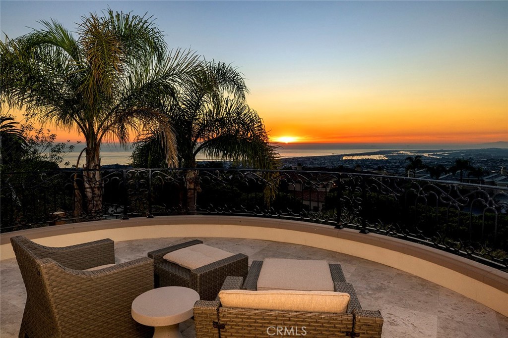 Perched atop a panoramic ocean view location with vistas that span from Catalina and Newport Harbor’s twinkling lights up the white-water California coast to Palos Verdes this resort inspired estate offers privacy and amenities leaving little to be desired. Located in the private 24/7 guard gated coastal community, Pelican Hill, this estate boasts 6 Bedrooms and 7 bathrooms at just over 9,216 sqft on a 18,924 sqft parcel. Neutral calm tones and an abundance of natural light and fresh ocean air flood the living areas marrying the ideal southern California coastal climate with the grand well-appointed interiors of the property. Large inviting common living and dining spaces located on the main level accompanied by wood clad office, gourmet kitchen, on grade garage, and bar all overlooking the stunning endless views. Primary and 3 secondary bedroom suites occupy the upper level of the residence while two bedroom suites, game room, living/ dining area, sauna and wine cellar reside on the properties lower level. Once outside you are transported into your own tropical oasis reminiscent of some of the finest ocean resorts outfitted with BBQ pavilion, fireplace lounge, sun deck, and pool with slide, waterfall and spa grotto lounge all surrounded by finely manicured and mature landscaping providing extreme privacy. This home represents one of the rare opportunities to own and reside in a custom residence in the highly sought-after Pelican Hill community and must be experienced to truly understand its year round beauty and amazing value.