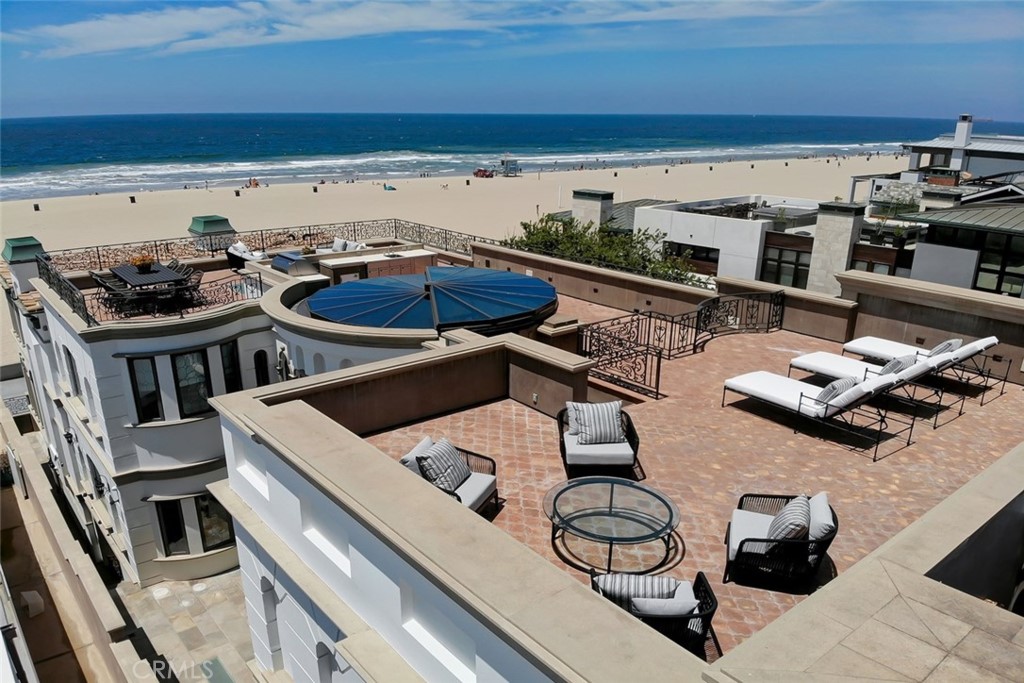 This impressive oceanfront villa delivers a premium property experience crafted on a scale and magnitude that will leave you speechless with its stunning design elements. For those seeking front-and-center beachfront living but also requiring privacy, this is your Strand home. A retracting 16' atrium window opens to a very rare, practically full-length rooftop deck engineered for a future rooftop pool! The over-sized beach level patio sits below The Strand offering another great entertaining environment tucked away from passersby, yet within a few steps of the beach. There are two fully-loaded Viking outdoor kitchens - one on the beachfront patio and the other on the rooftop. Influenced by the original owner's travels throughout Italy, no expense has been spared in creating this masterful trophy home. Every fine detail and amenity has been painstakingly planned; every aspect beautifully considered. From the expansive beach level great room with an 800 gallon saltwater aquarium to the hand-carved wood floors and imported Roman marble tub, there are too many amenities and details to present in a short description! This home simply must be experienced. Fully loaded with smart-home features, elevator & dumbwaiter, theater & gym, a 5' La Cornue range, and a private master "apartment" like you've never seen! Within a stone’s throw of the beach, there is easy access to the fine restaurants and the vibrant community scene found throughout North Hermosa and South Manhattan Beach.