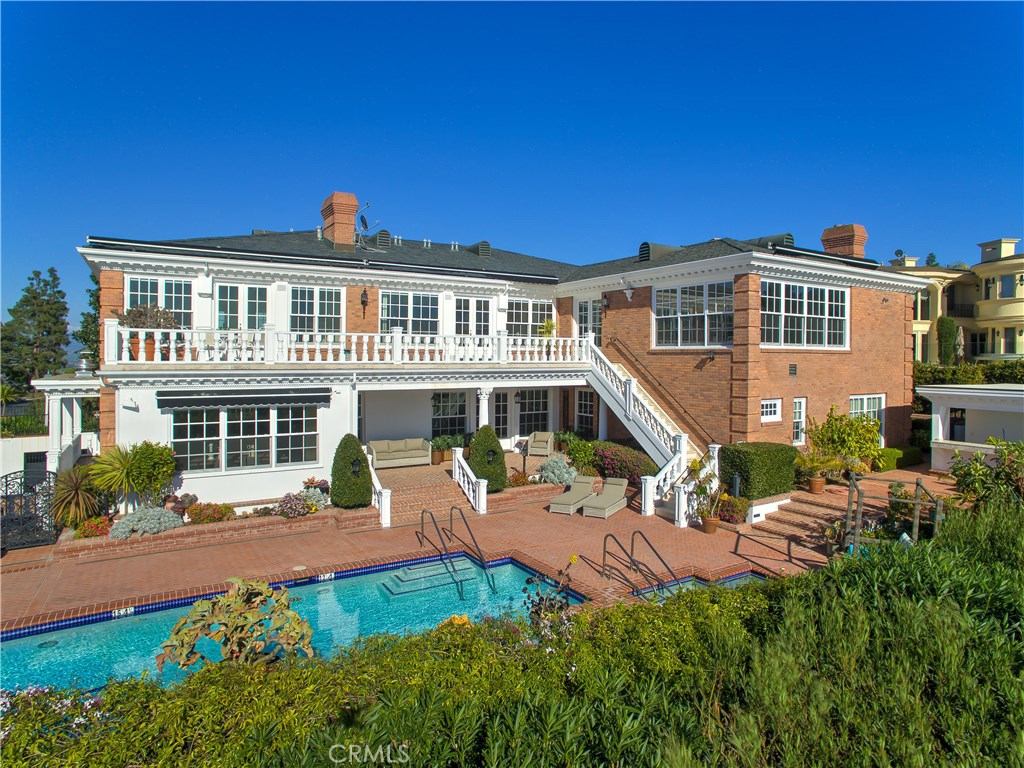 Located in the prestigious guard gated community of Harbor Ridge, this Southern Colonial mansion, over 11,800 square feet, showcases stunning Newport Harbor and Catalina sunset views! This estate home offers 7 bedrooms, 12 bathrooms and a charming guesthouse/pool cabana. A grand foyer welcomes you to the main level with a handsome library and an inviting family room. The spacious master suite is complete with spectacular views, beautiful fireplaces, and an ultra-luxe master bath. Two gourmet kitchens are equipped with Sub-Zero & Viking appliances. The backyard and two large terraces overlook a grand pool and spa, outdoor kitchen and guest house. State-of-the-art media room with theatre style seating, private elevator, well-appointed gym and game room with bar and relaxed club-style seating. Oversized laundry room, a four-car garage, a lush garden with an outdoor children’s playhouse. The ground floor boasts a spacious dance studio with ample custom-built storage. Newly installed Lutron lighting compliments the home and a commercial-grade generator is located adjacent to the four-car garages.