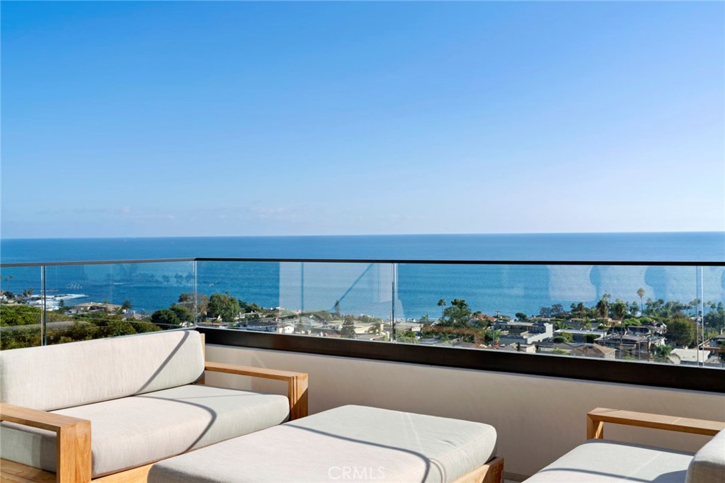 Enjoy breathtaking white water, ocean and island views from this most impressive North Laguna Beach soft contemporary. - Rarely does a newer construction home (built 2017) come available in N. Laguna Beach. - Before entering, you are welcomed by a vast pivoting glass door that offers an unbending view of the Pacific Ocean. Once inside this entertainers dream, you will find the main level with walls of glass and an open concept floor plan replete with panoramic water views from every room. The chef’s kitchen is a sight to behold with Wolf stainless steel appliances, coffee maker, two dishwashers, and a Sub Zero refrigerator conveniently disguised in the design. The ocean is your backdrop as you venture down to level two and three of this stunning en suite 4 bedroom, 6 bath, approximate 5000 square foot home. - Level two boasts ocean views from bedroom two and the expansive master suite with a fireplace, luxury en suite bath and an oversized walk-in closet with second private laundry room. Level three houses two en suite bedrooms, a gym room or wine cellar, and a large family room with a terrace expanding the width of the home. Also included are three fireplaces, an elevator accessible on all three floors, two laundry rooms, a three car garage and approved plans for a future cantilevered jacuzzi spilling into a planned 66’ lap pool with glass bottom deck.