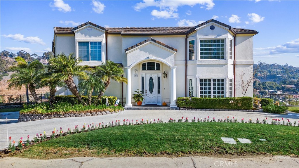 Pristine custom home built and owned by the original owners. Perfectly situated to enhance the picturesque 360 degree views of the hillsides, canyons and city lights. Welcome to 2034 Virazon Drive La Habra Heights! This 4 Bedrooms and 4.5 baths, an oversized primary suite with a retreat and viewing decks throughout the house. A huge closet that is the size of a small bedroom. Bedroom and bathroom downstairs can also be used as an office. Open floor plan; Family room opens to kitchen the features include high end appliances, custom built cabinetry and island, granite countertops and more. The quality materials and workmanship are notable. A purchased 4,000 Watt solar system, central vac, fire sprinklers. Roll down automatic shutters, two water heaters and two A/C units to increase the comfort and efficiency of the home. The grounds are sprawling, easy access from the street with a circular driveway for additional parking. 3 car garage. There is a separate large storage area at the rear of the property.