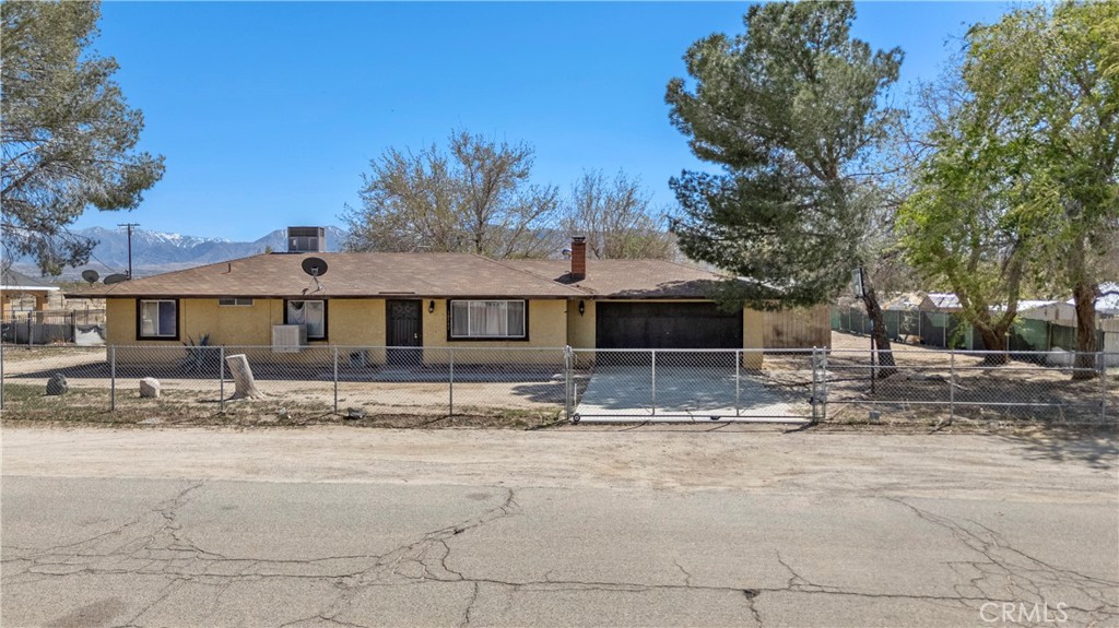 Welcome to 10542 E Avenue S-14. Escape to the tranquility of the desert with this cozy single-family home. This 3-bedroom, 2-bathroom home with a Den that provides endless possibilities for customization. Tile throughout the house and a cozy fireplace. Large patio in the backyard to enjoy the outdoors. Property is completely fenced for security. Situated on almost 1 acre, plenty of space to build a garden or add an ADU. House is located on a well-maintained paved road. Close to major Highway 138 and Highway 14. Whether you’re looking for a weekend getaway, a peaceful home to call your own, or a project to bring your vision to life, this property offers the perfect blend of potential and tranquility. It’s an ideal opportunity for buyers looking to create their dream home in the desert.Must see to appreciate. Schedule your viewing.