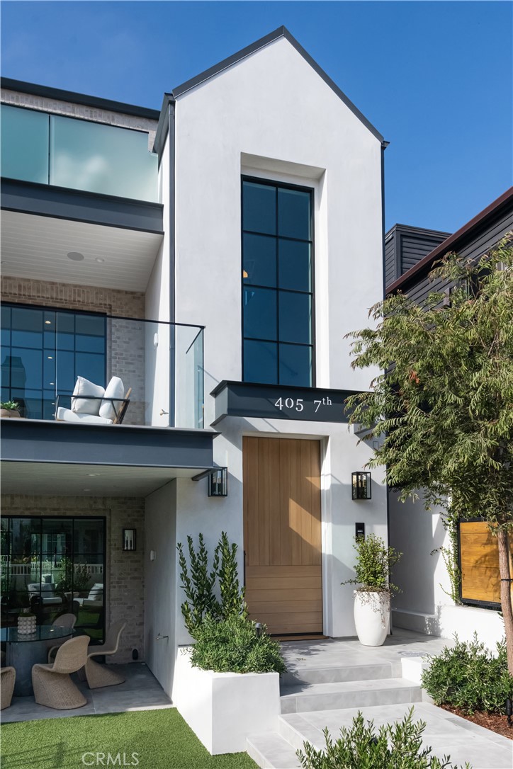 An absolute breath of fresh air within the world of new construction spec homes, 405 7th Street masterfully embodies quiet sophistication and modern luxury, commanding the attention it rightfully deserves. This brand-new home is perfectly positioned on one of the most sought-after walk streets in Manhattan Beach, with the spacious front yard facing South, ideal for the Southern California sunshine all-year round. From the very beginning, this home was set up for excellence - Built by the renowned RJ Smith Construction, with interior design by Wendy Word and architectural brilliance by Joseph Fournier.
Every finish and fixture feels like it was made specifically for this home and curated to blend pacific natural elegance with modern functionality. The thoughtfully designed Beach Room on the walk-street level perfectly embodies the indoor-outdoor surf & sand lifestyle. Its front yard, featuring lush landscaping and drought-tolerant turf, seamlessly extends to the expansive Avalon limestone covered patio, which connects directly to the interior through large glass pocket doors. Striking Encaustic tile floors, a chic wet bar adorned with quartzite countertops, Zellige backsplash, and custom hand-blown glass light fixtures elevate this multi-functional space into a work of art. Stunning Otiima steel-framed windows and doors throughout maximize natural light, creating a seamless, airy connection across all three levels. The main level captures the essence of beach living with wide plank oak floors, a living room balcony that welcomes ocean breezes from just four blocks away, and an open floor plan ideal for entertaining or enjoying a quiet evening. The tasteful finishes throughout this level, including reeded and fluted cabinetry, Calacatta Gold natural stone kitchen counters, and organic ceramic brick backsplash, introduce an exciting modern twist to a warm beach pad.
The kitchen is decked out with Thermador Appliances, wine fridge, ice machine, walk-in pantry and all the bells & whistles you expect from a cook’s kitchen. The primary suite offers a resort-like ambiance with clean lines, high ceilings, and a spa-like en suite bathroom including a soaking tub, steam shower and large walk-in closet ready for customization. Few locations can rival this one- just blocks from the sand, and a short walk to the downtown shops and dining that are quintessential Manhattan Beach.